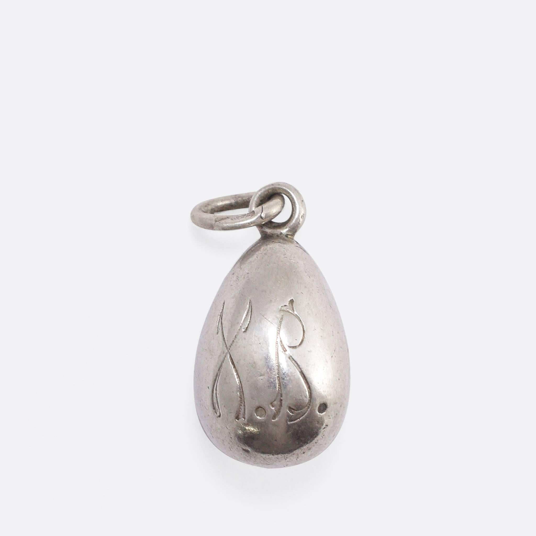 This antique Russian miniature egg pendant features a finely enamelled cherub on one side, and X.B. (Christ is Risen) on the other. Modelled in 84z (.875 grade) silver, the bail displays clear Russian marks dating it to c.1910. Of the exceptionally