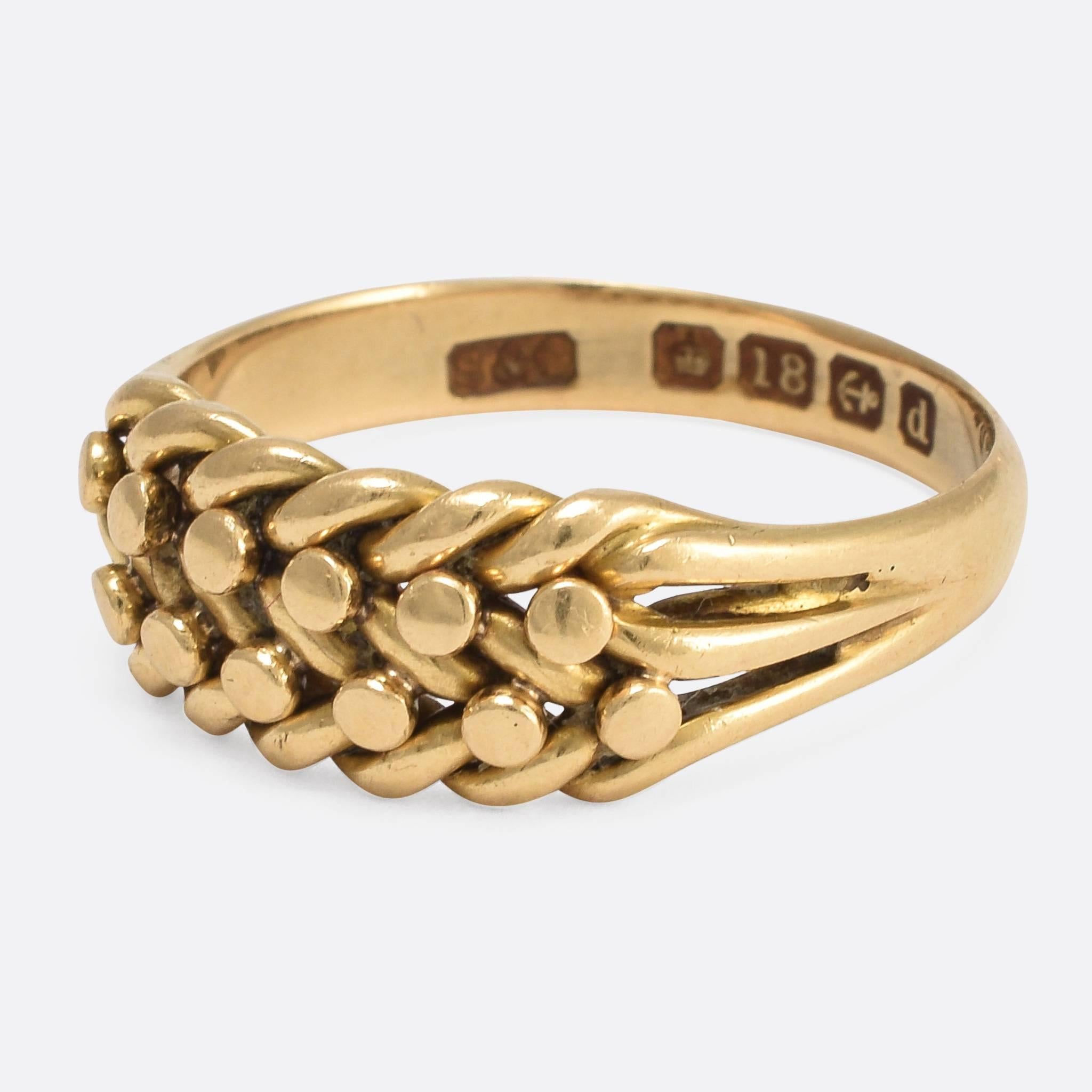 This elegant braided keeper ring dates to the very early 20th Century, bearing clear English hallmarks for the year 1903. It's modelled in rich 18k gold, and has developed a beautiful antique patina of the last century. A particularly high quality