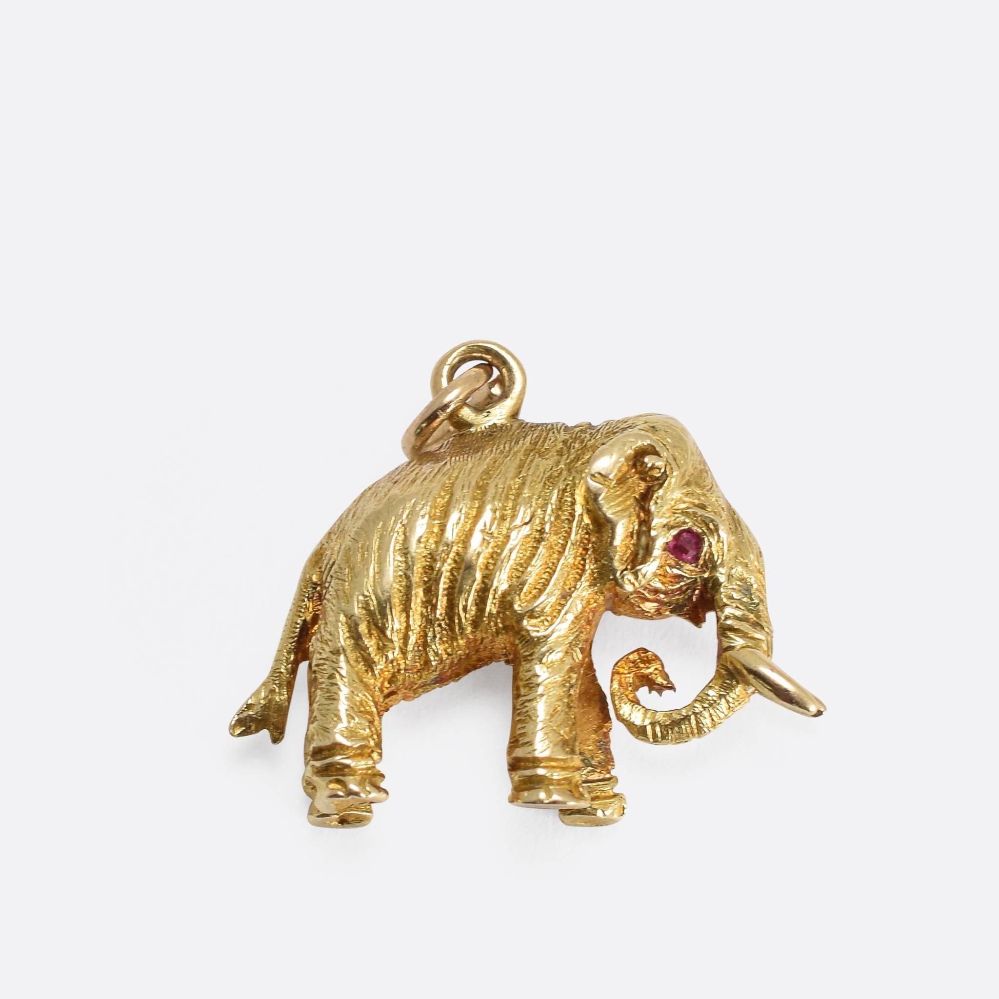 The mighty elephant, beautifully modelled in 15k yellow gold with rubies for eyes. It dates to c.1900 and has a great look - fully hand-chased all over with realistic skin detailing.