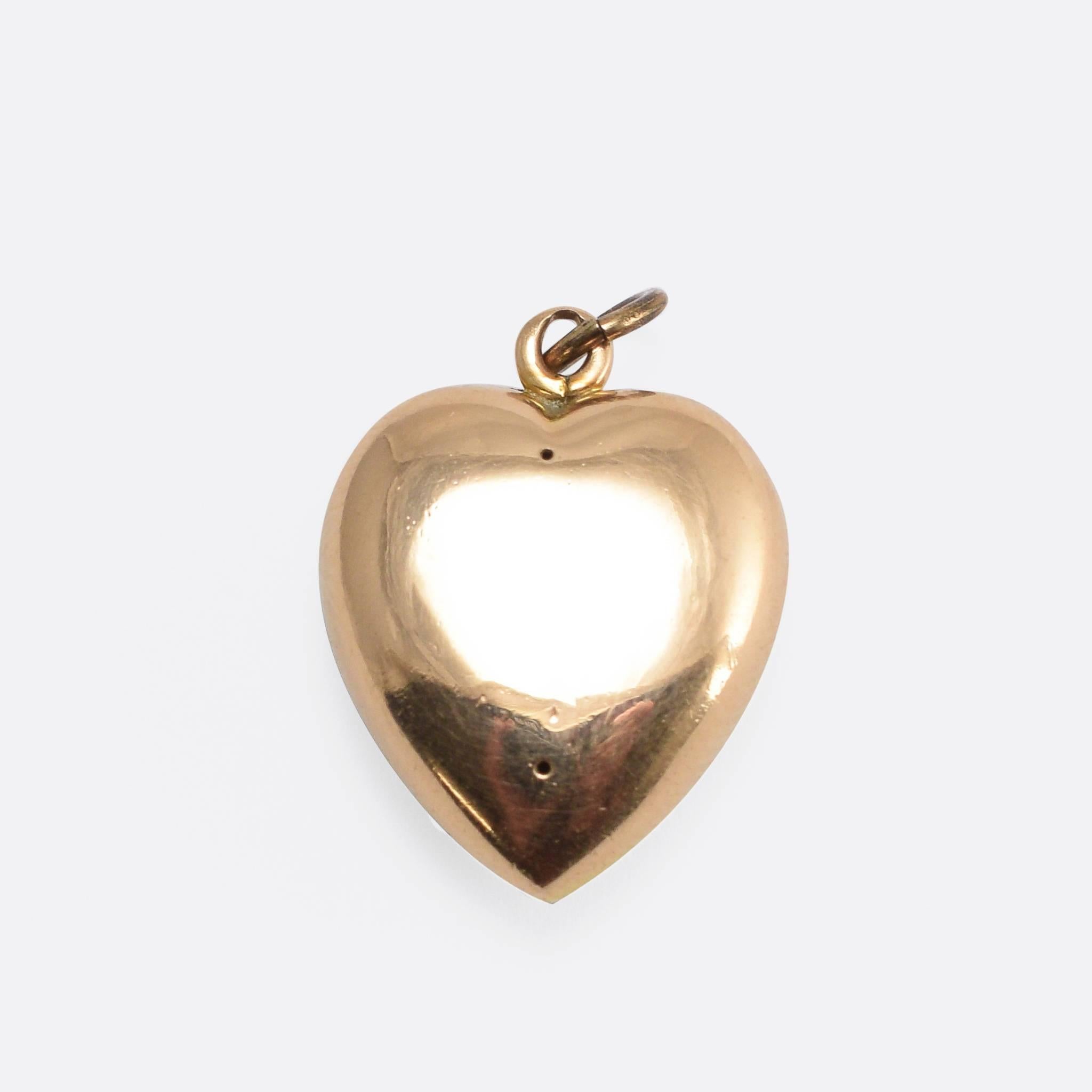 This pretty antique heart pendant is pavé set with seed pearls. It's modelled in 15k yellow gold, and dates to the late 19th Century. The word pavé is French, and literally translates to English as 