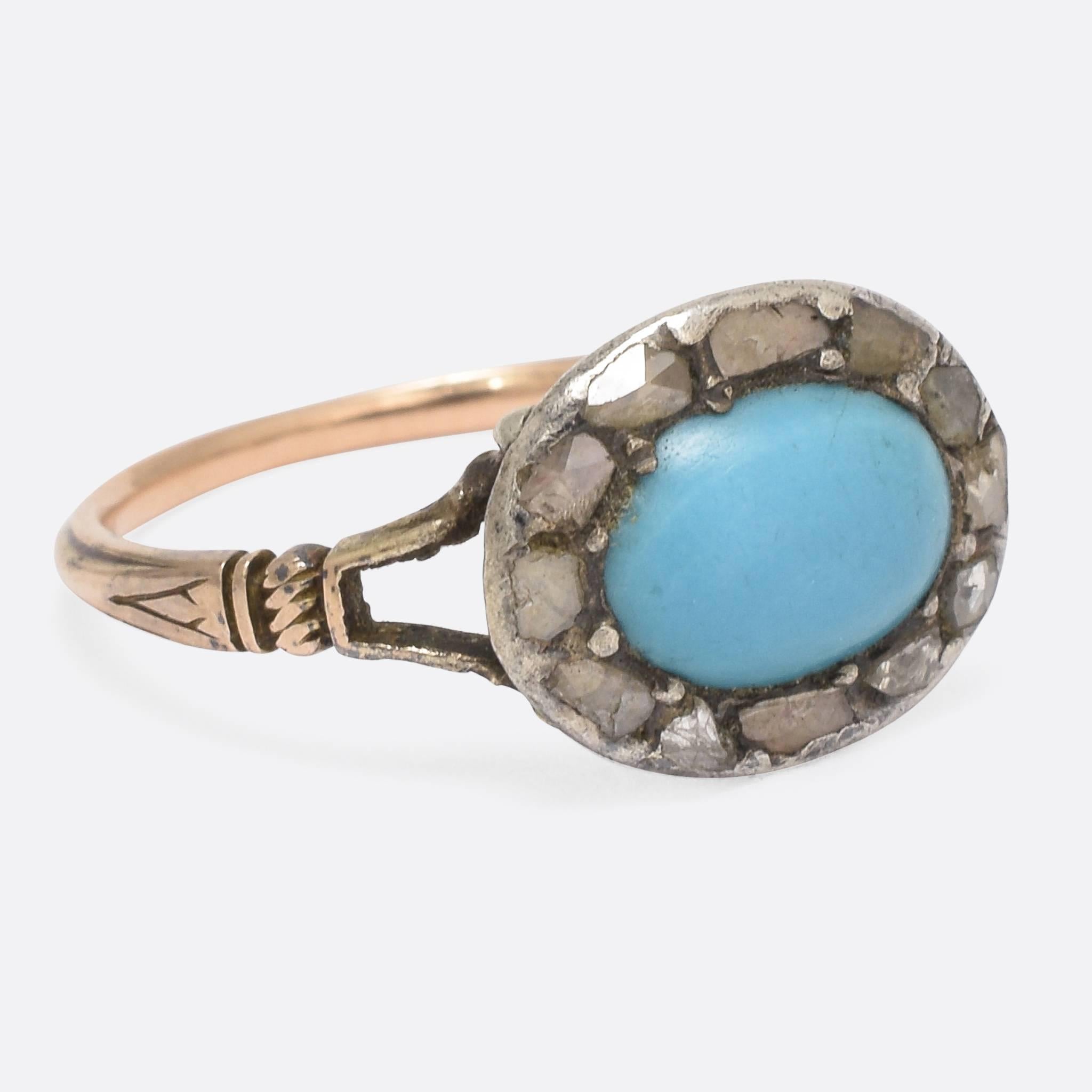This elegant George III period cluster ring is set with a central turquoise cabochon, surrounded by a halo of glistening rose cut diamonds. The closed backed head features attractive fluted detail, and the split shoulders display futher hand-chased