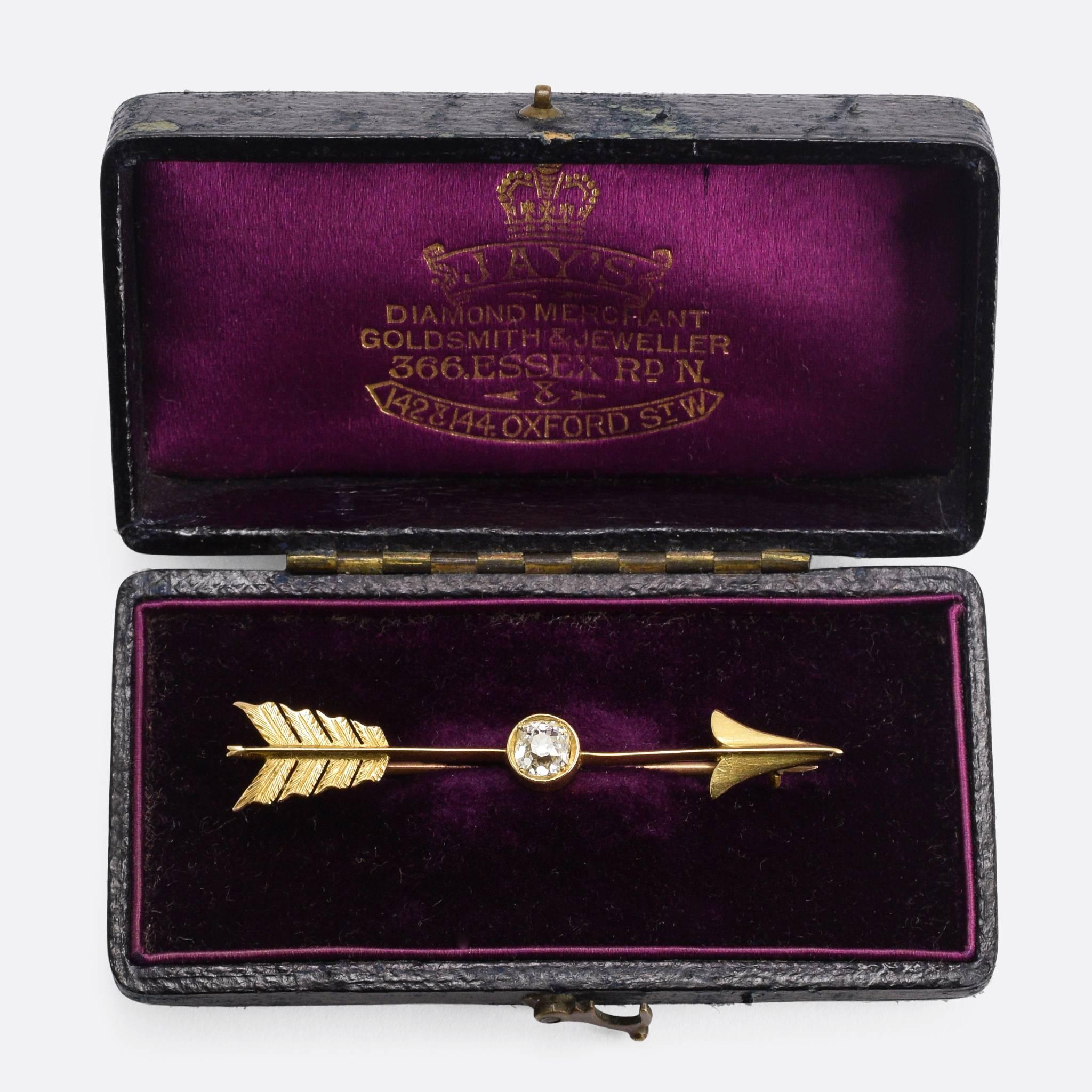 This cool antique arrow brooch is set with a superb .65ct old mine cut diamond at the centre. The feathers feature fine hand-chased detailing, and the piece is modelled in 15k gold throughout. In the Victorian era, the arrow was a symbol of love