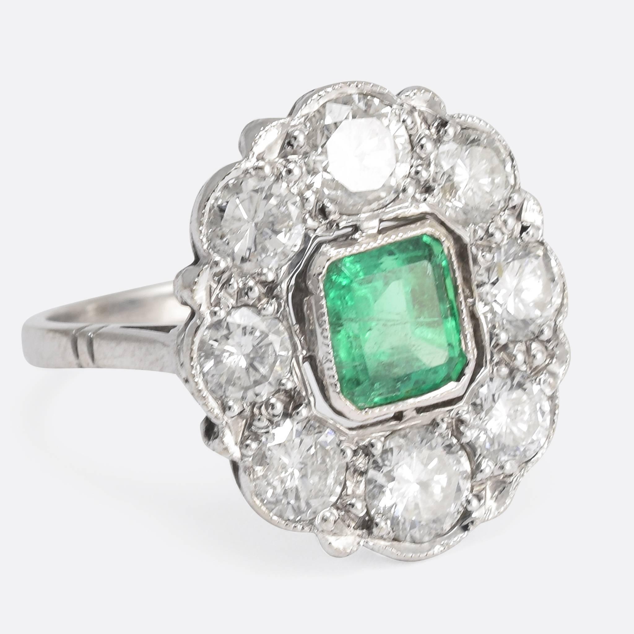 This stunning antique cluster ring dates to the late Edwardian period, and is home to a, exquisite central emerald – of excellent colour – and a 1.72ct cluster of brilliant cut diamonds. The ring is modelled in 18k white gold, with the stones set in