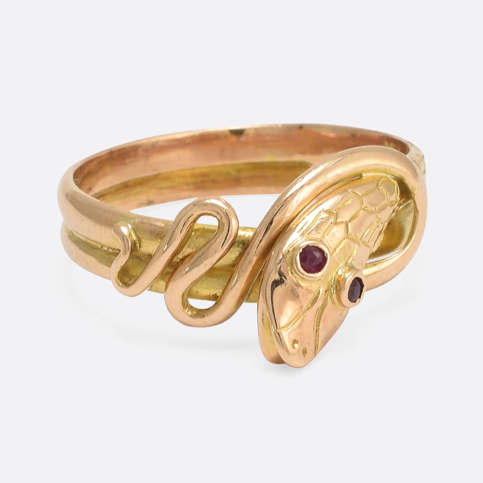 This antique snake ring is a particularly fine example of the style, modelled in 18k rose gold and set with faceted ruby eyes. The head is beautifully textured, with scale details and a cheeky open mouth. The snake body wraps around the finger