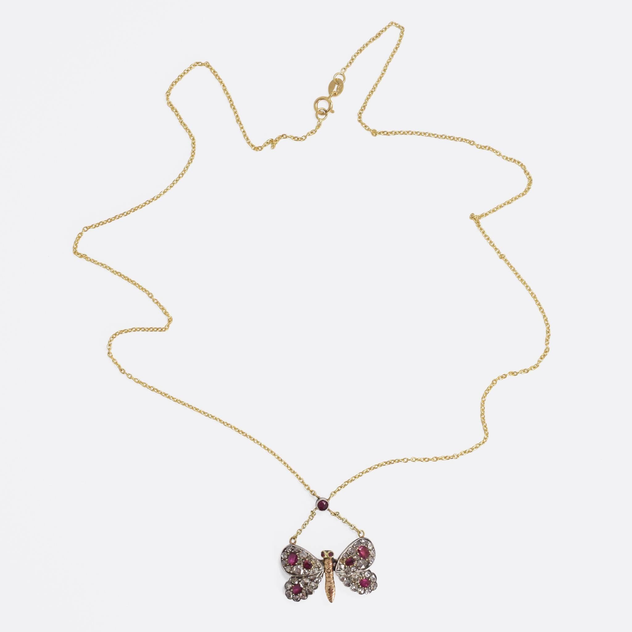 This adorable antique necklace is fashioned as a diamond-studded butterfly, with vibrant ruby accents. The butterfly itself is likely of Russian origin, and came to us as a pin brooch. Our jeweller has added a 9k yellow gold chain, with a further