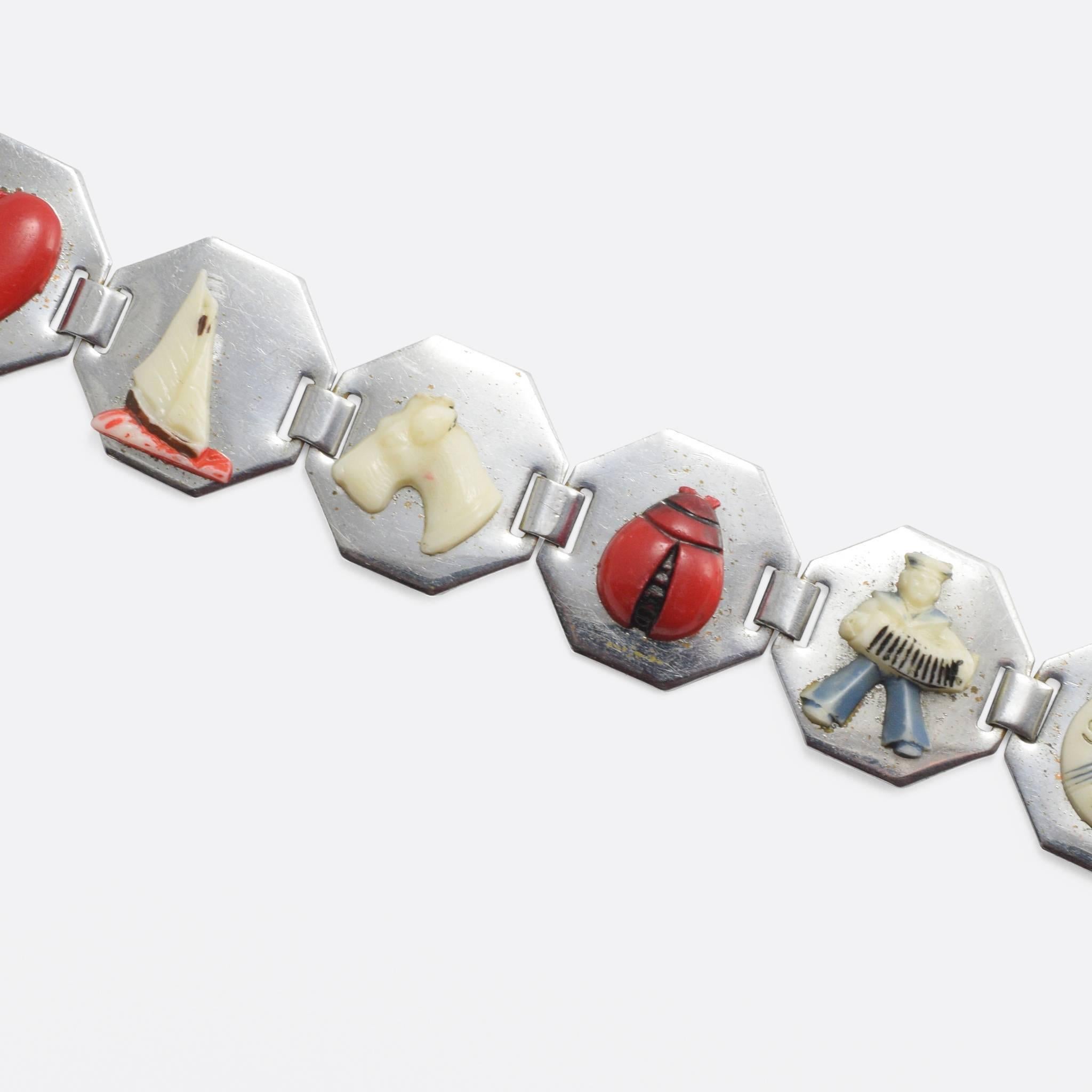 This fun vintage bracelet comprises 8 chrome panels, each set with a painted plastic charm. The plastic use here is celluloid, considered the first thermoplastic it was invented in 1856 as parkesine before taking on the name celluloid in 1870. Its