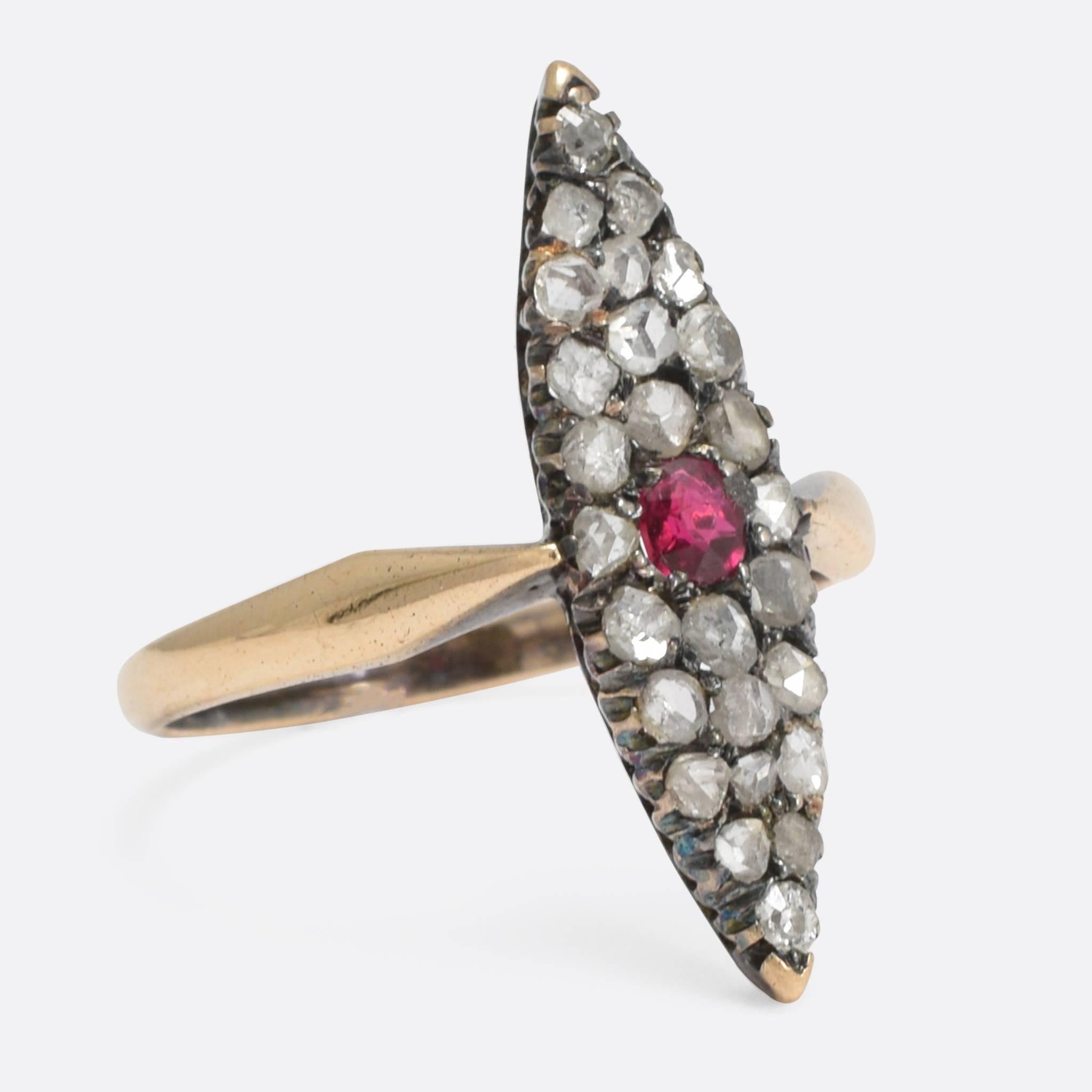 The cool antique cluster ring has a pointed marquise-shape head, fully set with rose cut diamonds and a vibrant central ruby. It's modelled in 15k yellow gold, with delicate claw settings and shapley pinched shoulders. An elegant ring, that has
