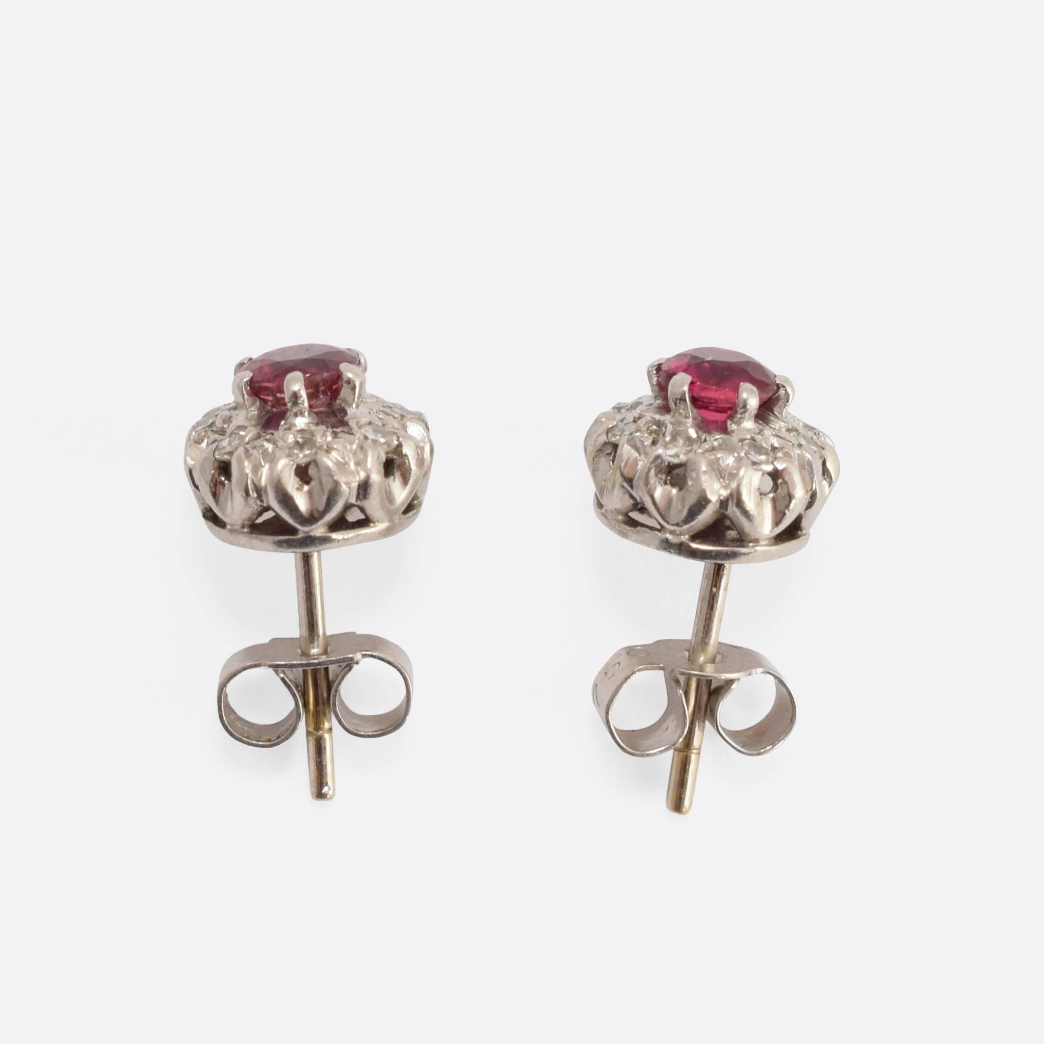 This sublime pair of cluster earrings date to the Art Deco period, c.1930. These exceptional studs are set with bright central rubies, each surrounded by a halo of diamonds. They're modelled in 18k white gold, and a good size at just under 1cm wide.