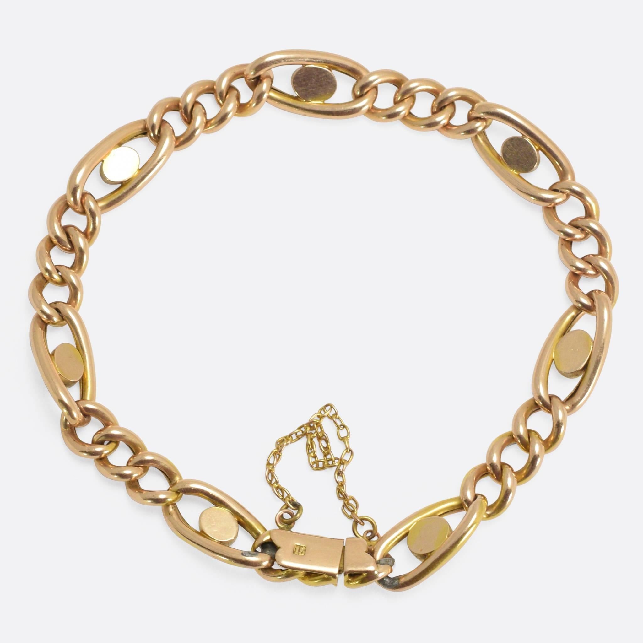 This elegant antique bracelet is modelled in 15k yellow gold, the classic curb-links modelled in 15k yellow gold. Every fourth link is formed as a wider oval, with a turquoise cabochon stone set in the centre, the design does not look unlike an eye