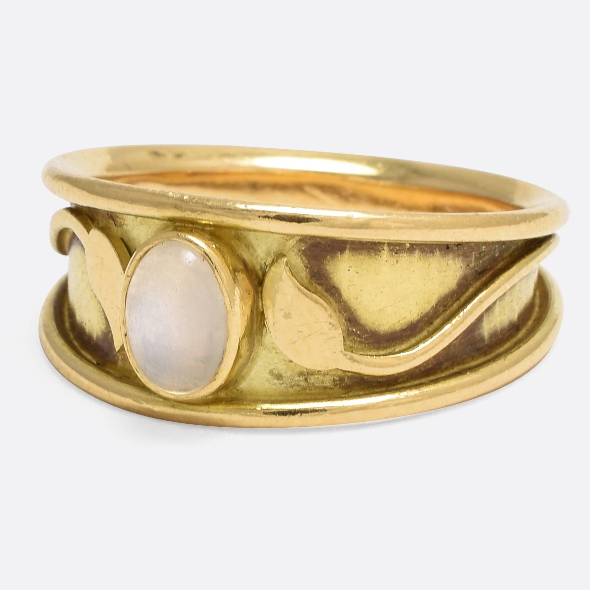 This stylish vintage ring was made by the popular jewellery designer Elizabeth Gage, and is a fine example of her early era work. Set with an oval moonstone cabochon, the ring features leaf and branch motifs, harking back to the styling of the Art