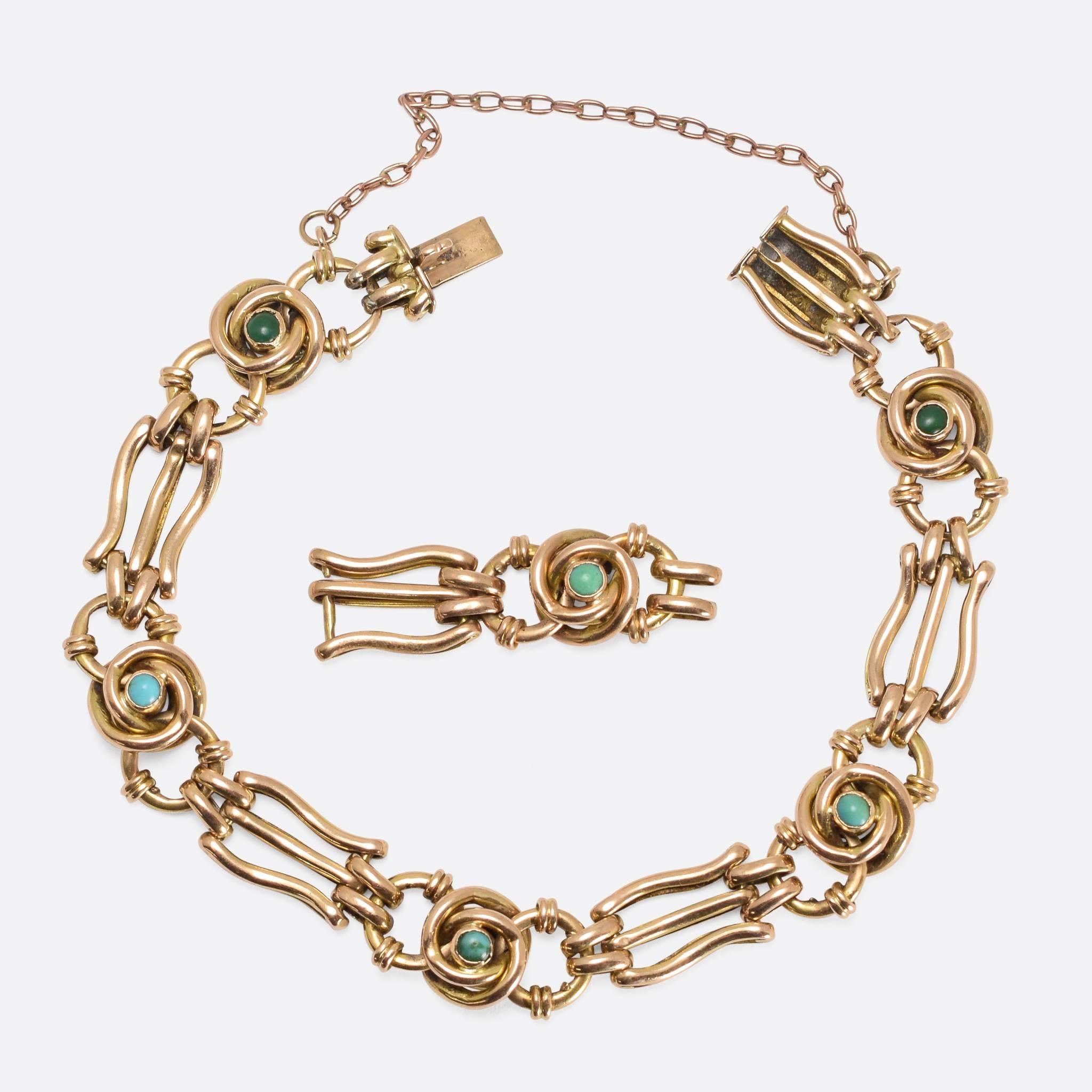 This elegant 15k gold bracelet is set with natural turquoise cabochons, with attractive alternating lyre and infinity knot links. The styling is very typical of the Art Nouveau era, with graceful curves and lines inspired by nature themes. Also