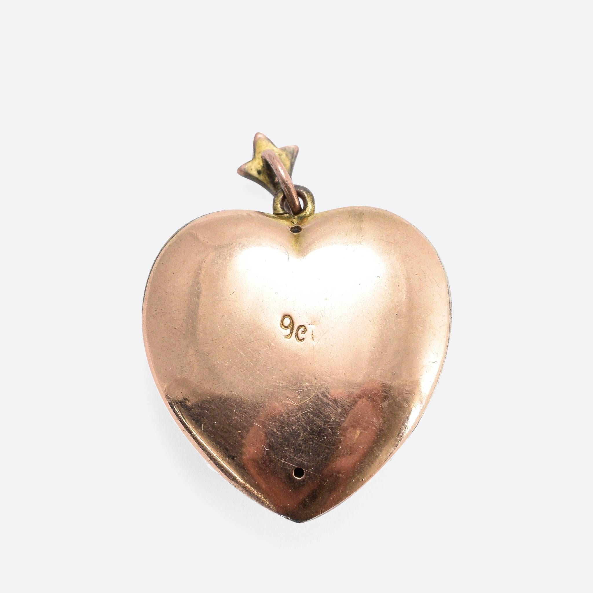 This beautiful antique heart pendant is pavé set with pearls, and a cute pink paste heart motif. It's modelled in 9k gold, with the original pearl-set bail. An attractive late Victorian piece, unusual with the flower detail.