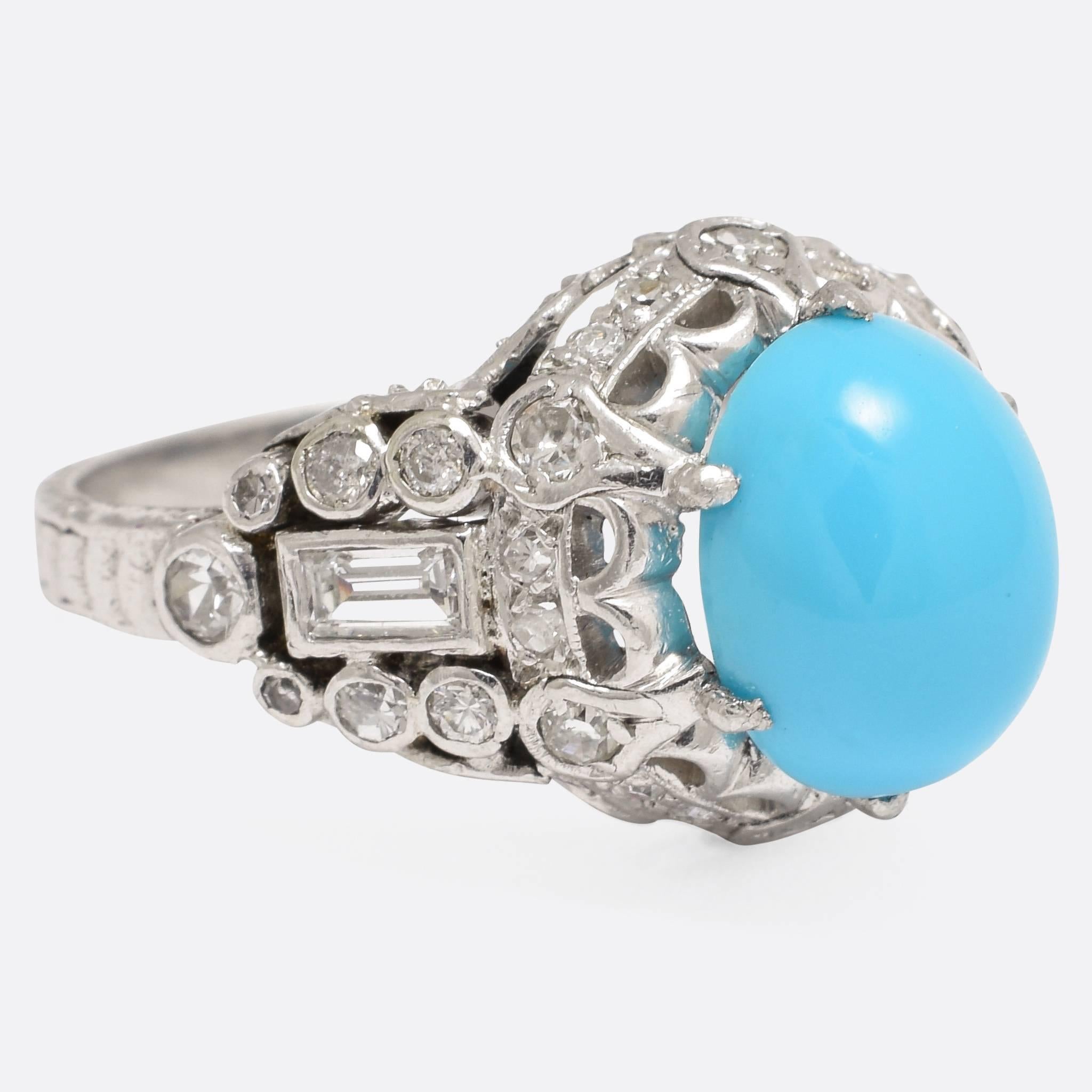 A magnificent, highly ornate 1930s cocktail ring - French and in the Art Deco style. The principal stone is a vibrant Persian turquoise, set with a combination of baguette and eight-cut diamonds. The head features gorgeous openwork, with millegrain