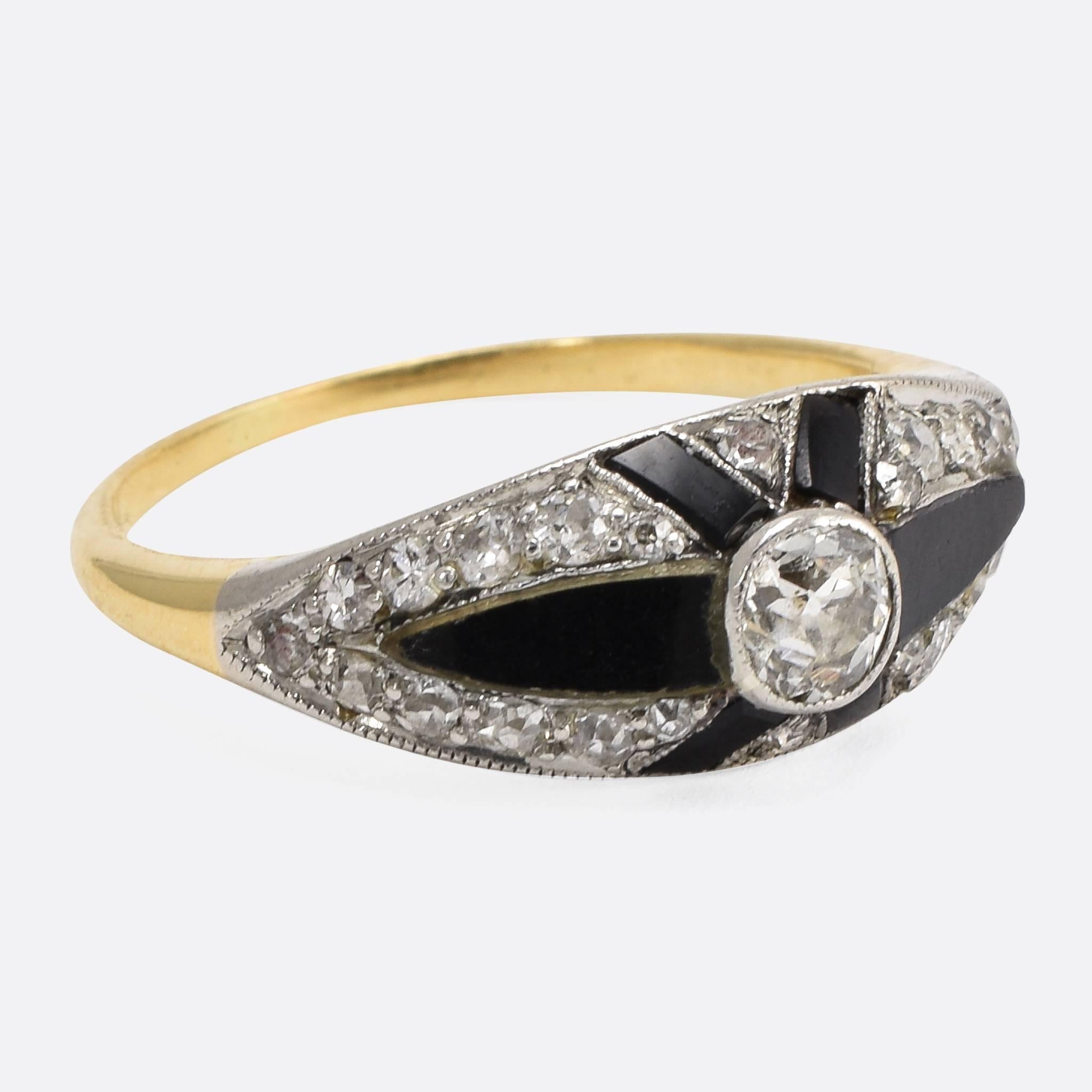 This superb Art Deco cocktail ring is set with black onyx panels, alongside a cluster of old cut diamonds and a principal .33ct cushion cut. The contrast between the onyx and diamonds is particularly striking, as is the X shape that frames the