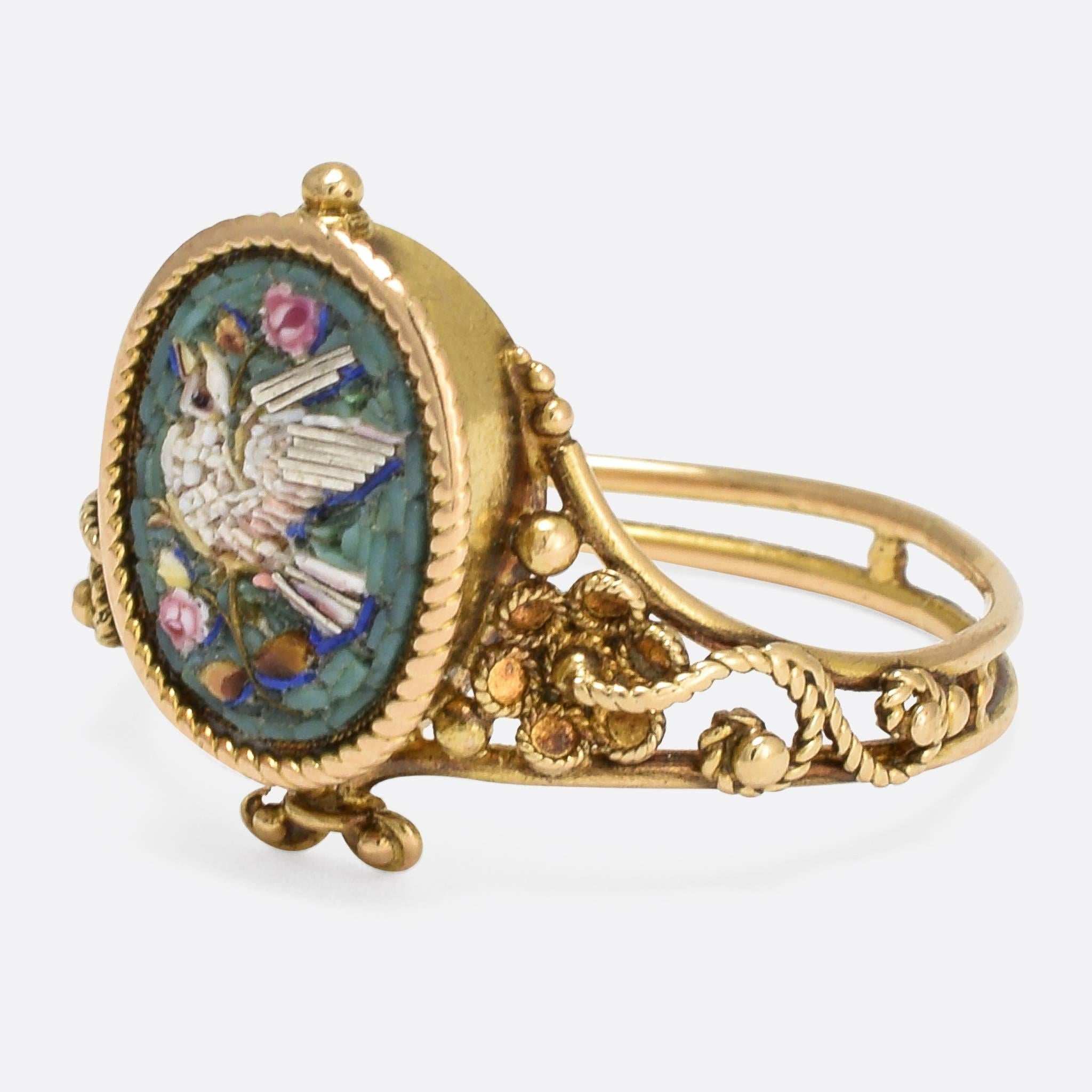 This beautiful antique ring dates to the mid-Victorian era, c.1870. It's likely of French origin, and features an adorable micromosaic panel depicting a dove and flowers - on a powder blue background. Unusually, the micromosaic includes silver inlay