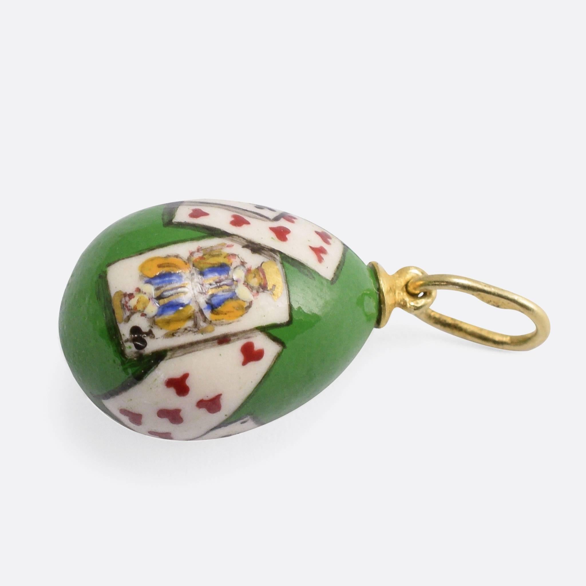 A charming antique miniature egg pendant, with beautiful enamelling that depicts playing cards - including the King and Queen of Spades - on a green background. A wonderful example of the style, featuring the exquisite Russian craftsmanship we would