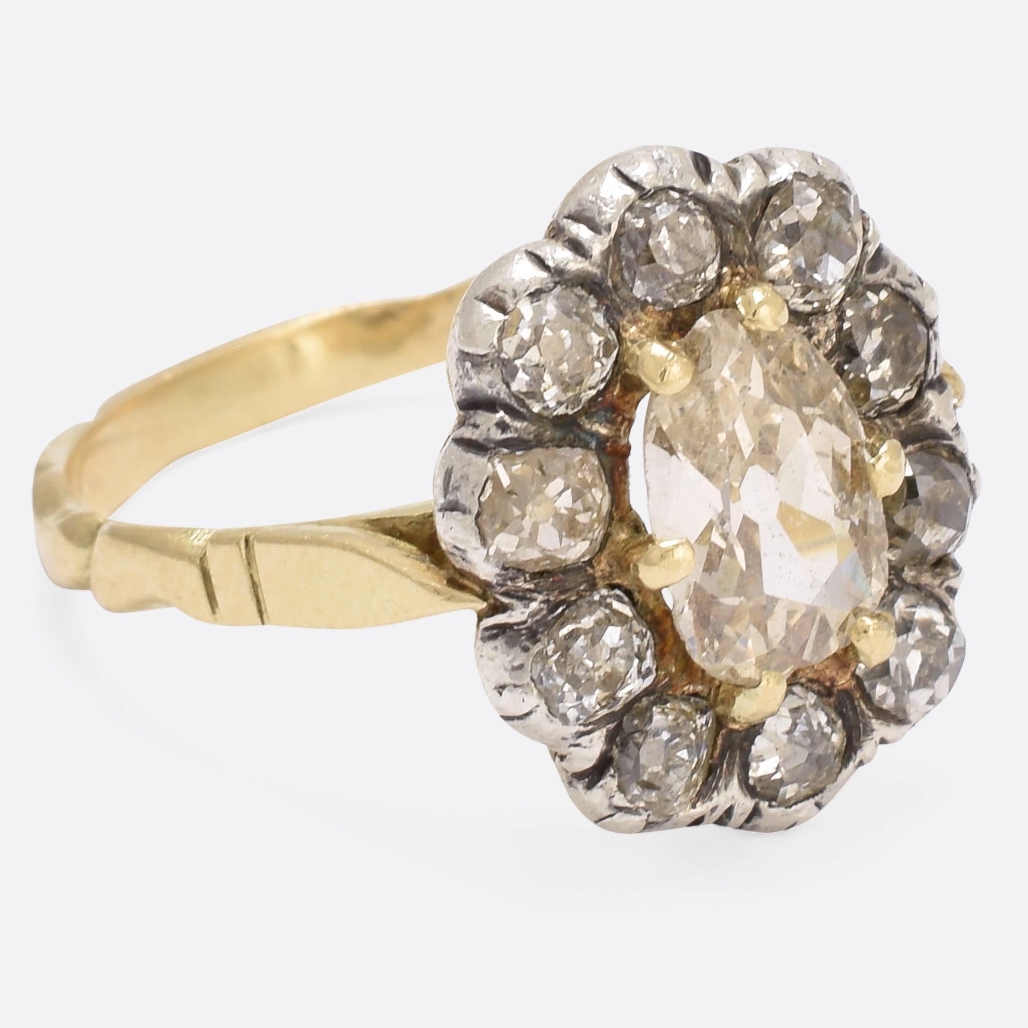 This magnificent Georgian diamond cluster ring is set with a gorgeous old pear cut champagne diamond, surrounded by a cluster of old mine cuts - total diamond weight 2.5 carats. Resting on a rococo style band, the head was once closed backed but has