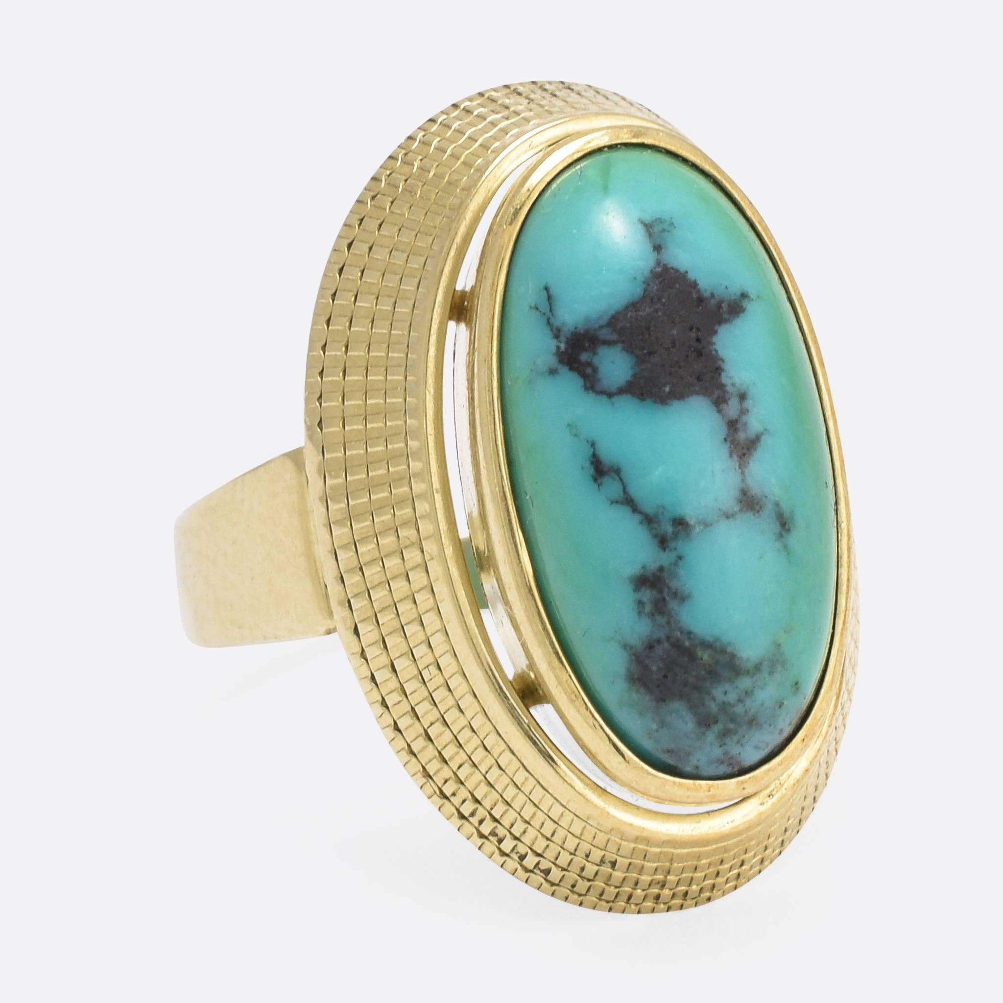 This fabulous 1960s statement ring was made in Germany, and has a real Egyptian Revival flavour to the design - of course mixed with classic '60s styling. The natural turquoise matrix cabochon is a long oval shape, and so beautiful. Ring size: 7.25.