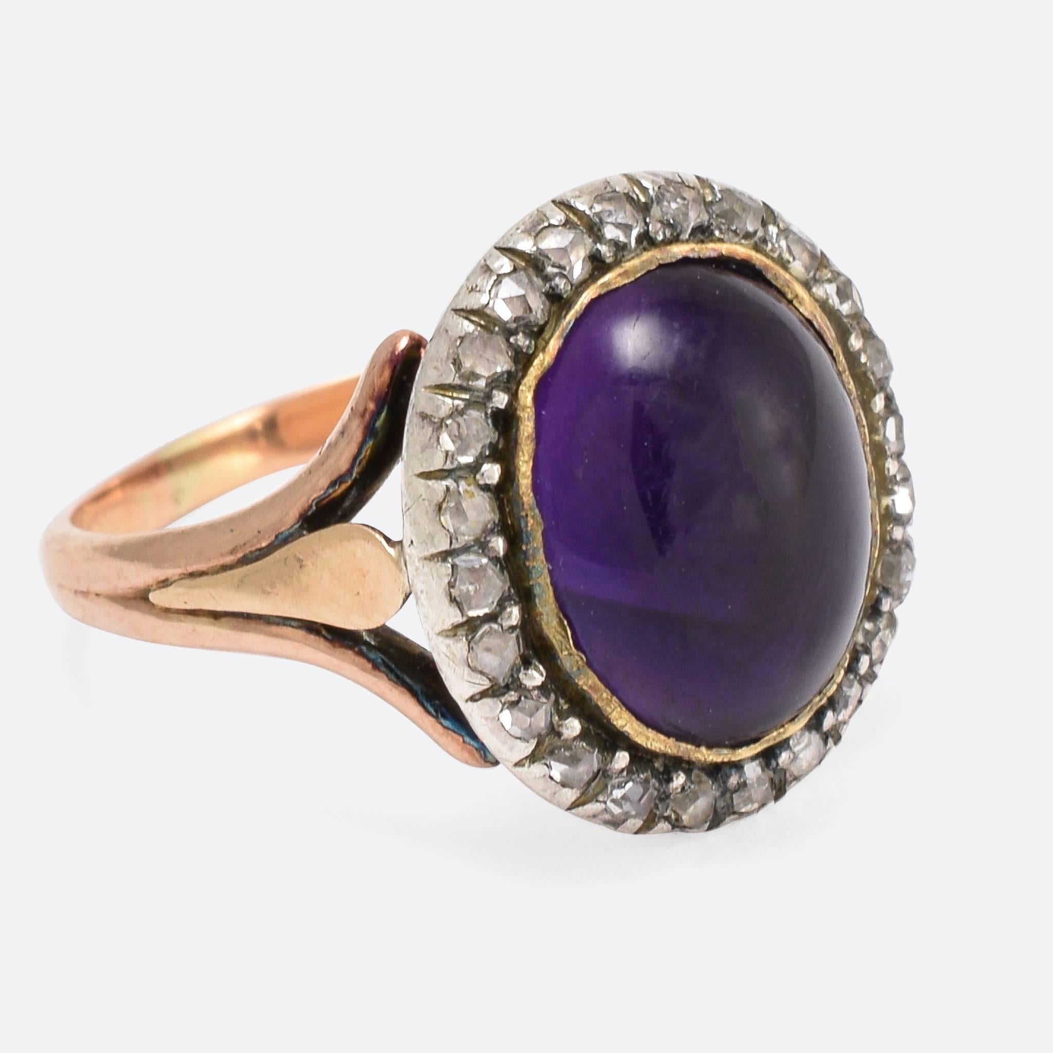 A beautiful Georgian period amethyst cluster ring, with a cluster of rose cut diamonds around the principal stone. The shoulders are spilt three ways, and the head is closed backed. Size 3.75.