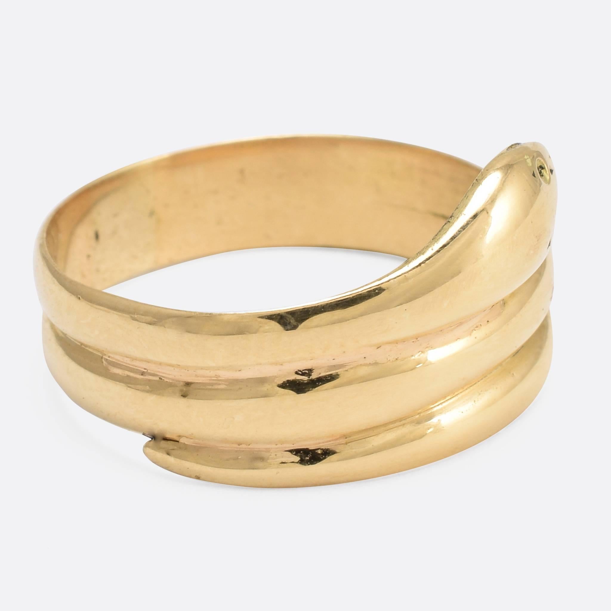 A cool 18k gold coiled snake ring, dating to the late 19th Century. The serpent coils around the finger twice, with a cute face and relatively slender profile for this style. A high quality piece of timeless design. Serpent jewellery has been