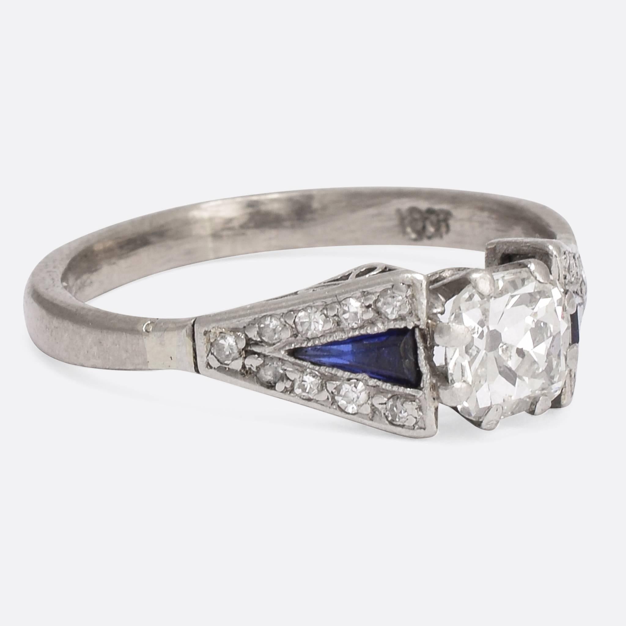 A beautiful Art Deco period Sapphire & Diamond engagement ring. The principal stone, a 60pt modified old mine cut, has most likely had it's table enlarged to add brilliance to the stone. The shoulders are set with natural calibre cut sapphires with