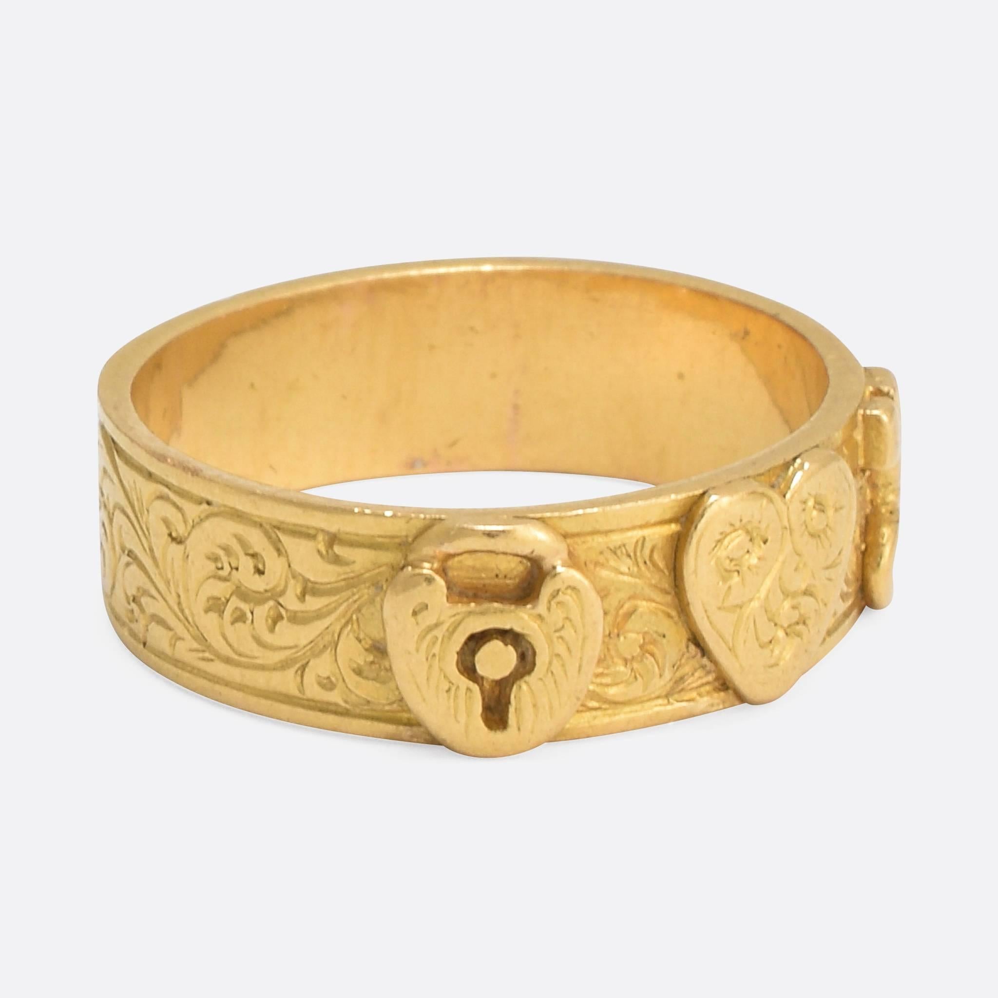 An exceptionally good quality mid/late 19th century 18k Gold wedding band, the front with applied lock and key with a central love heart, symbolising the giver owns the key to the receivers heart. Ring size: 4.75.