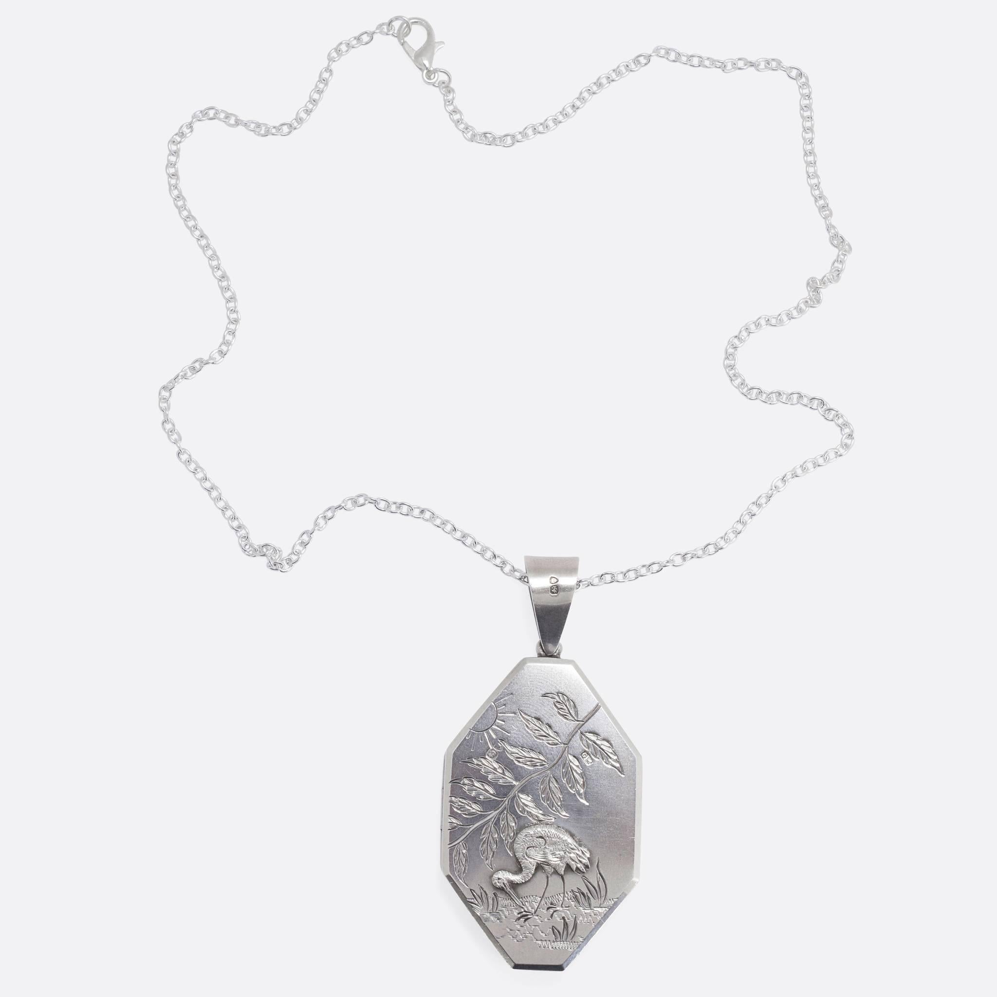 A cool antique octagonal locket in Sterling Silver. The face depicts a stork, wading through marshland, beneath a branch with leaves and a stylised sun - all beautifully hand-chased. With clear London hallmarks dating to the year 1879, and complete