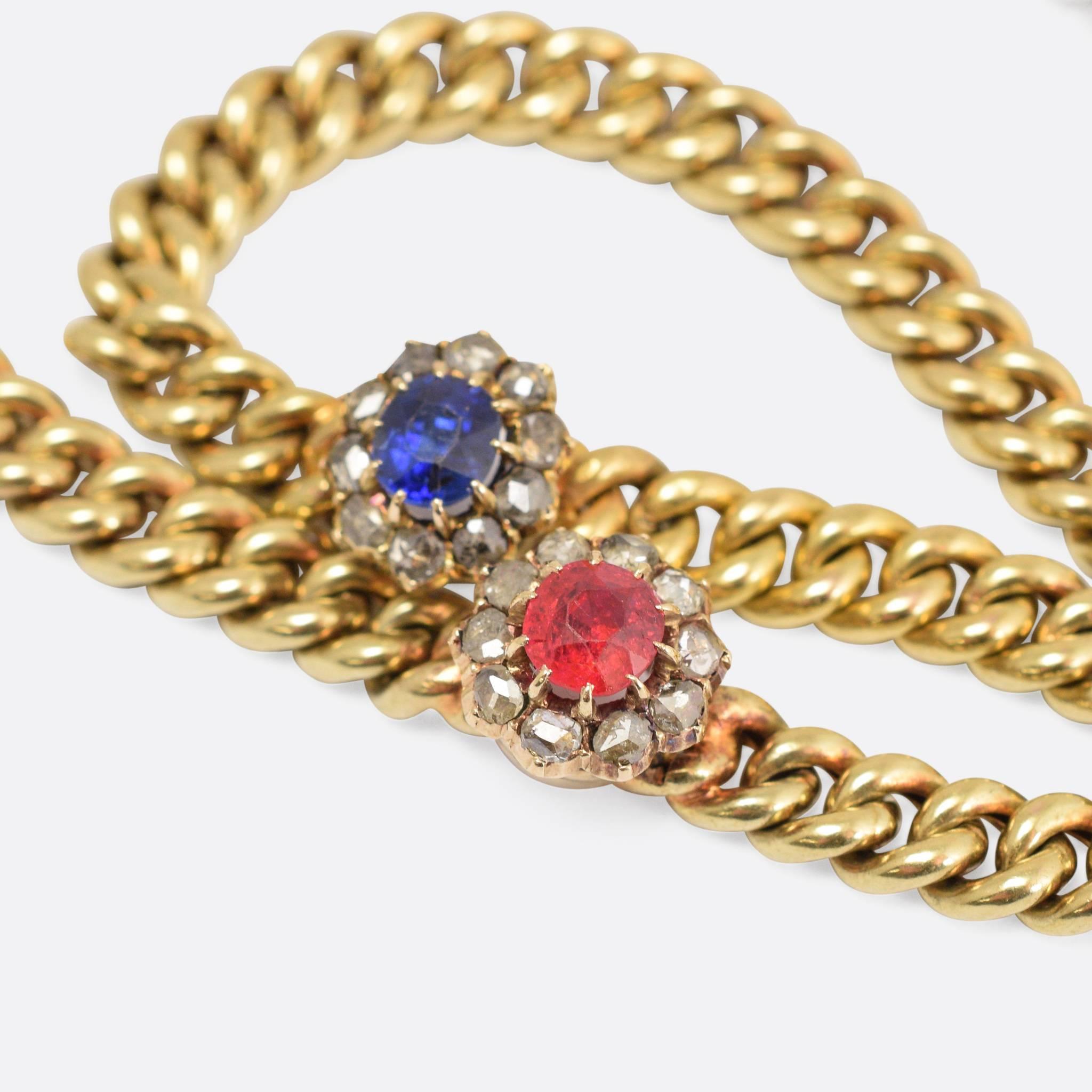 A fine quality 15k gold curbed link chain set with two clusters, a natural sapphire and ruby surrounded my rose cut diamonds. With original box snap fastener, the gold has a lovely buttery yellow hue and sits relatively highly on the wearers neck. 
