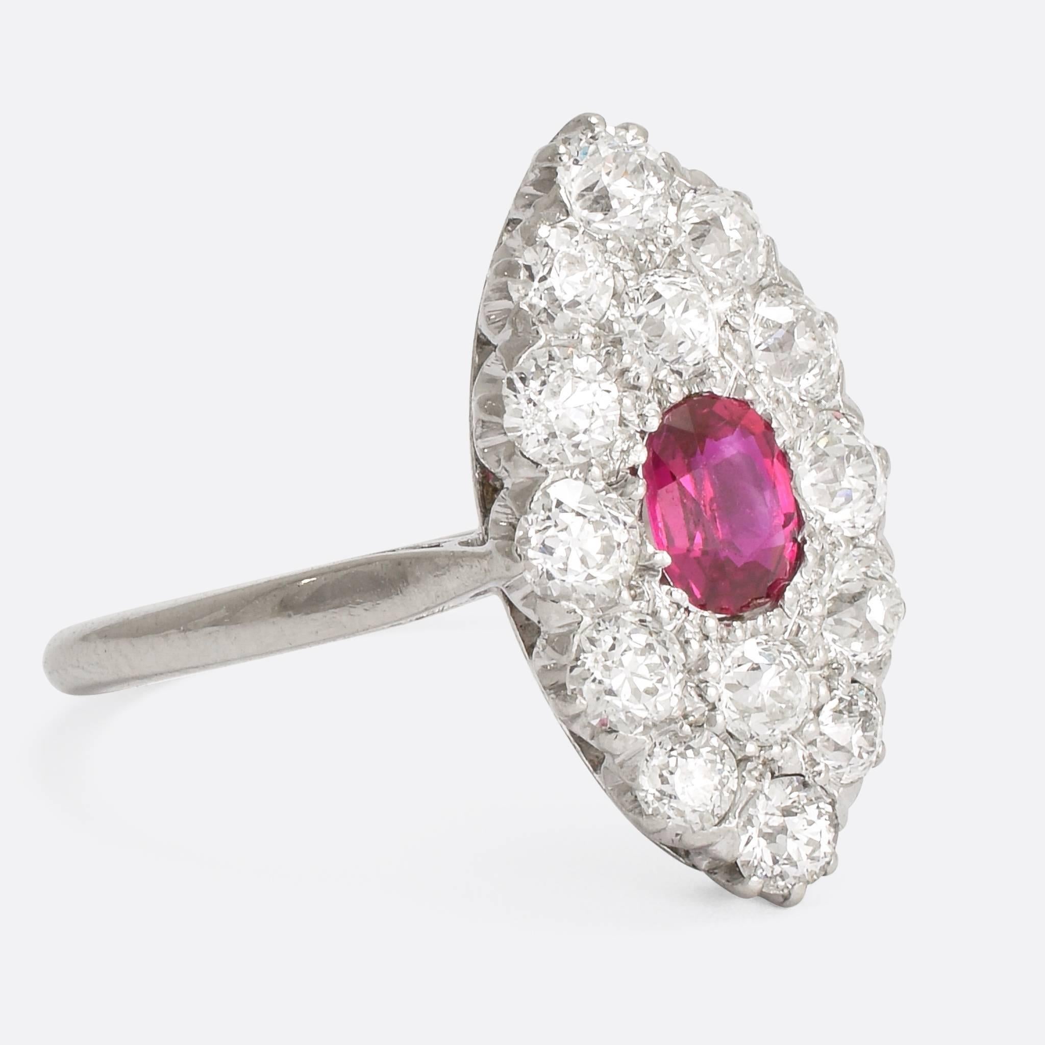 A superb Edwardian marquise cluster ring, set with a vibrant central ruby and a 1.6ct cluster of old cut diamonds. Modelled in platinum throughout, the ring dates to c.1910 - with an exceptionally bright cluster of diamonds in elegant claw settings.