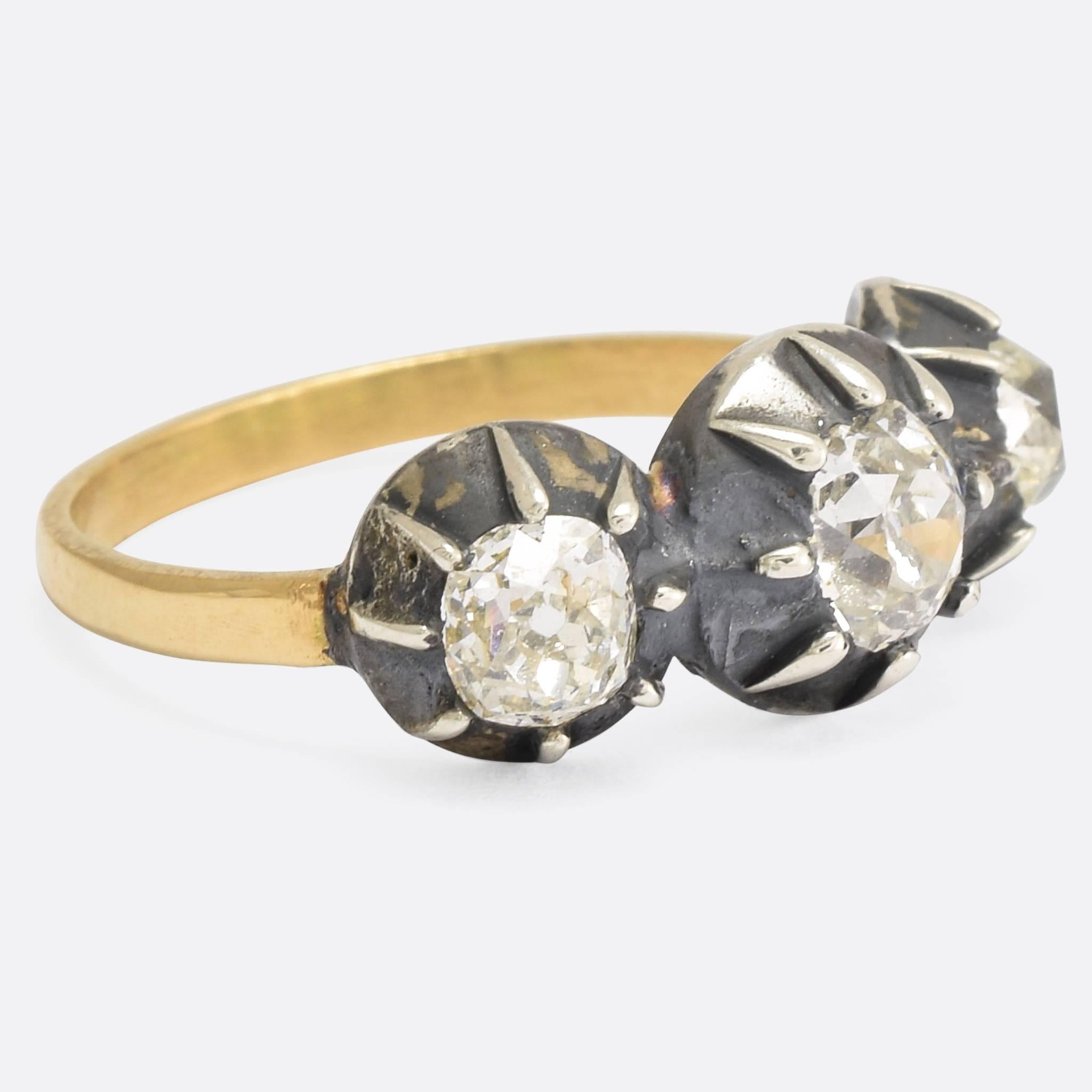 This wonderful Georgian ring is set with three deep old mine cut diamonds, in silver claw settings typical of the era. The stones are particularly clean and bright - the back having been opened to allow light behind them, further enhancing the