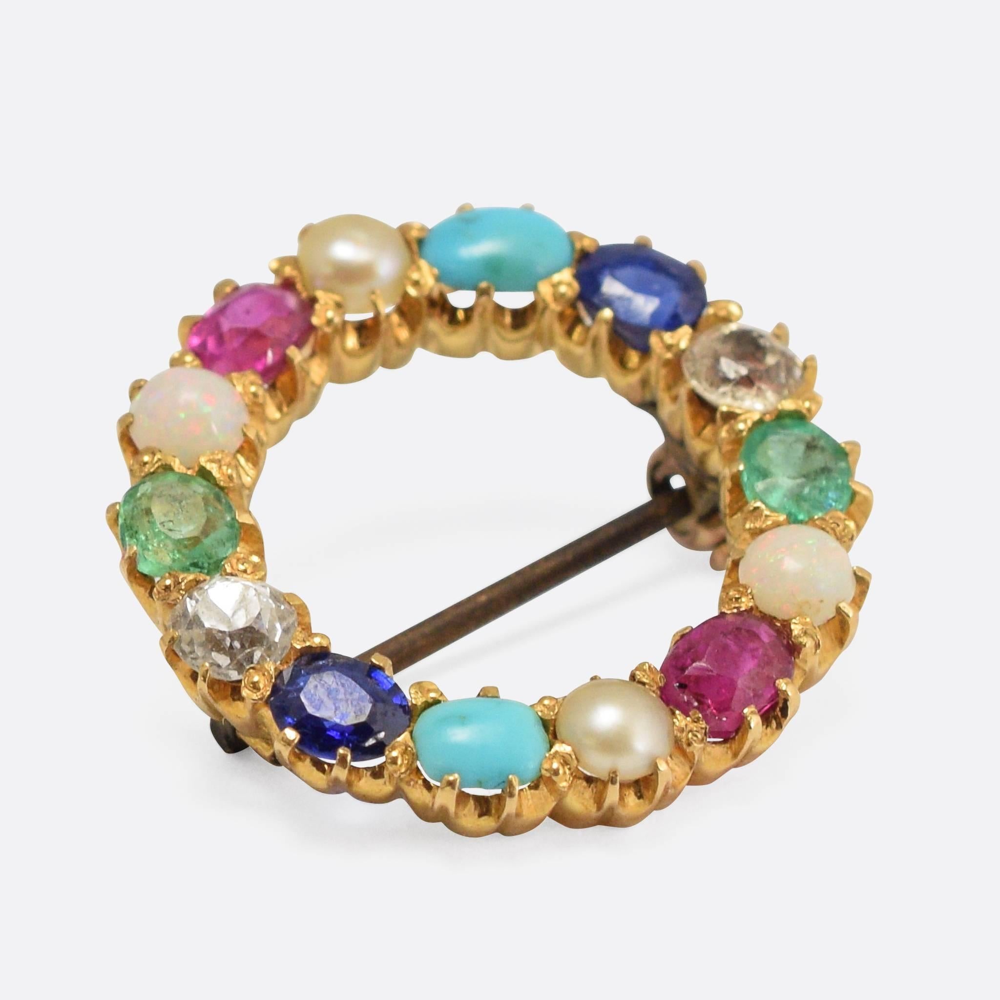 An excellent antique Halo Brooch set with harlequin stones: a combination of pearl, diamond, emerald, turquoise, ruby, sapphire, and opal. Modelled in 15k yellow gold, with the stones resting in stylish scalloped claw mounts. Set with natural pearl,