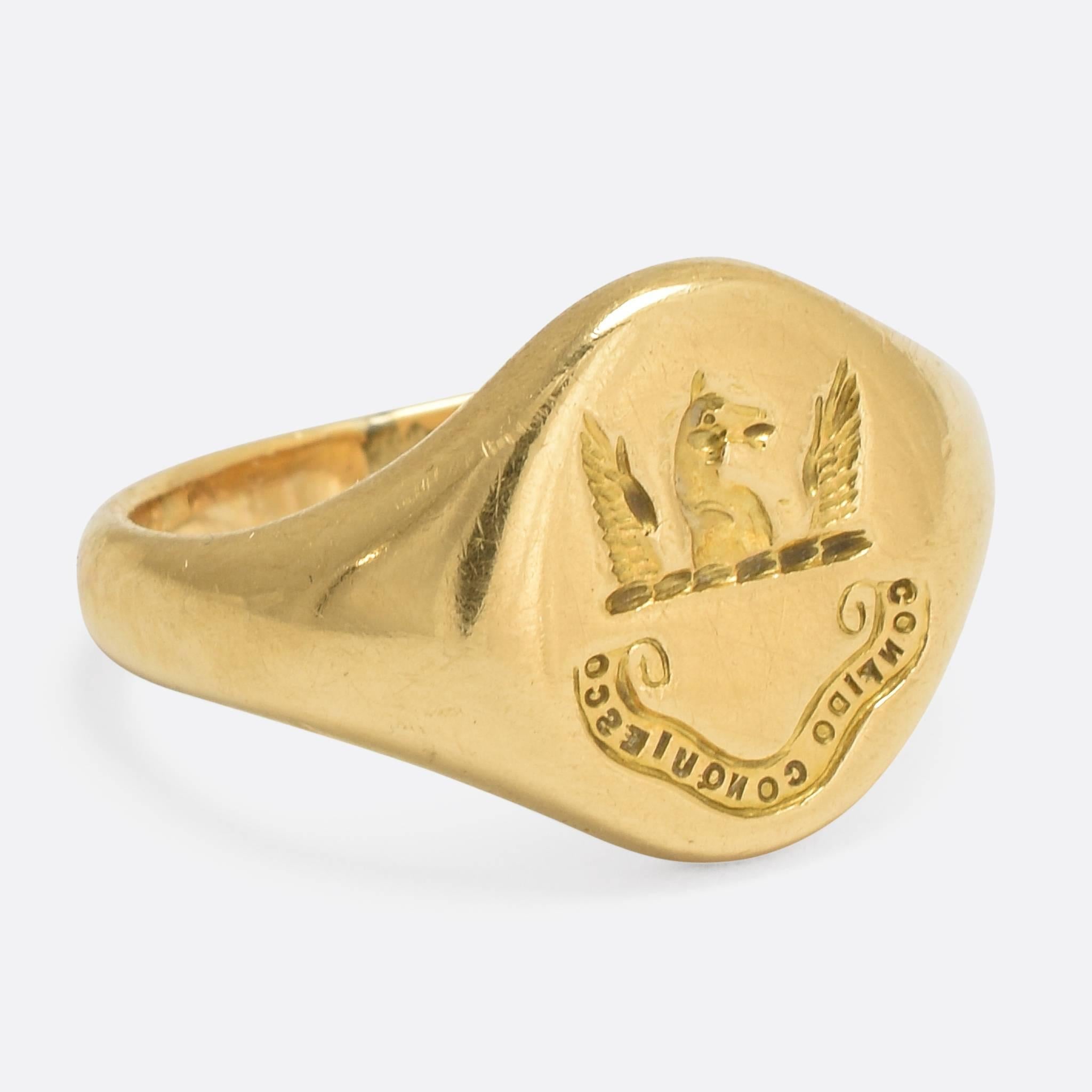 An interesting antique signet ring, the round head features an intaglio crest: a horse's head, winged, above a scrolled Latin motto 