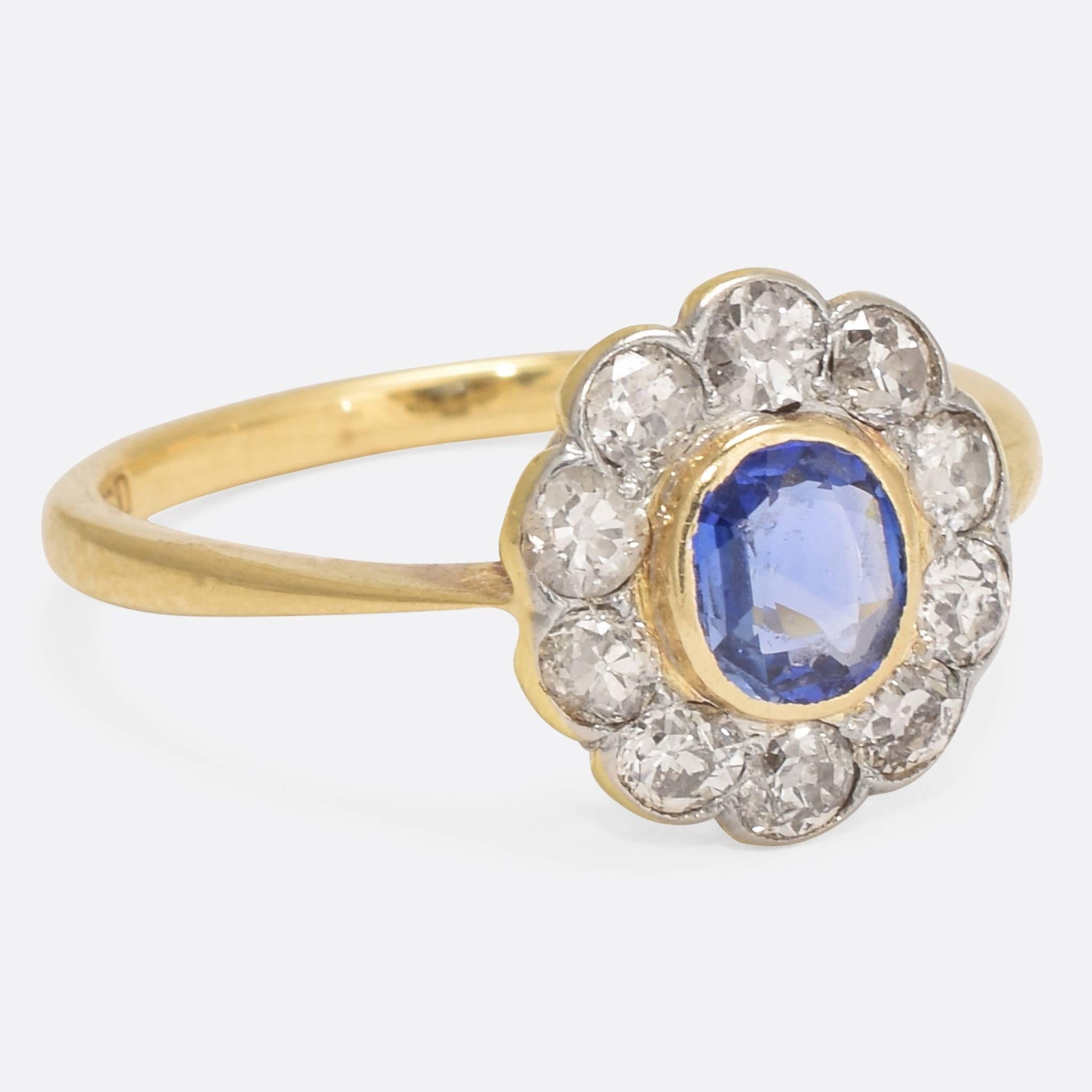 An especially beautiful Edwardian Sapphire and Diamond cluster engagement ring, dating to c.1910. The central cornflower blue sapphire is surrounded by a .80ct cluster of old Euro diamonds - the latter set in platinum. The band is modelled in 18k