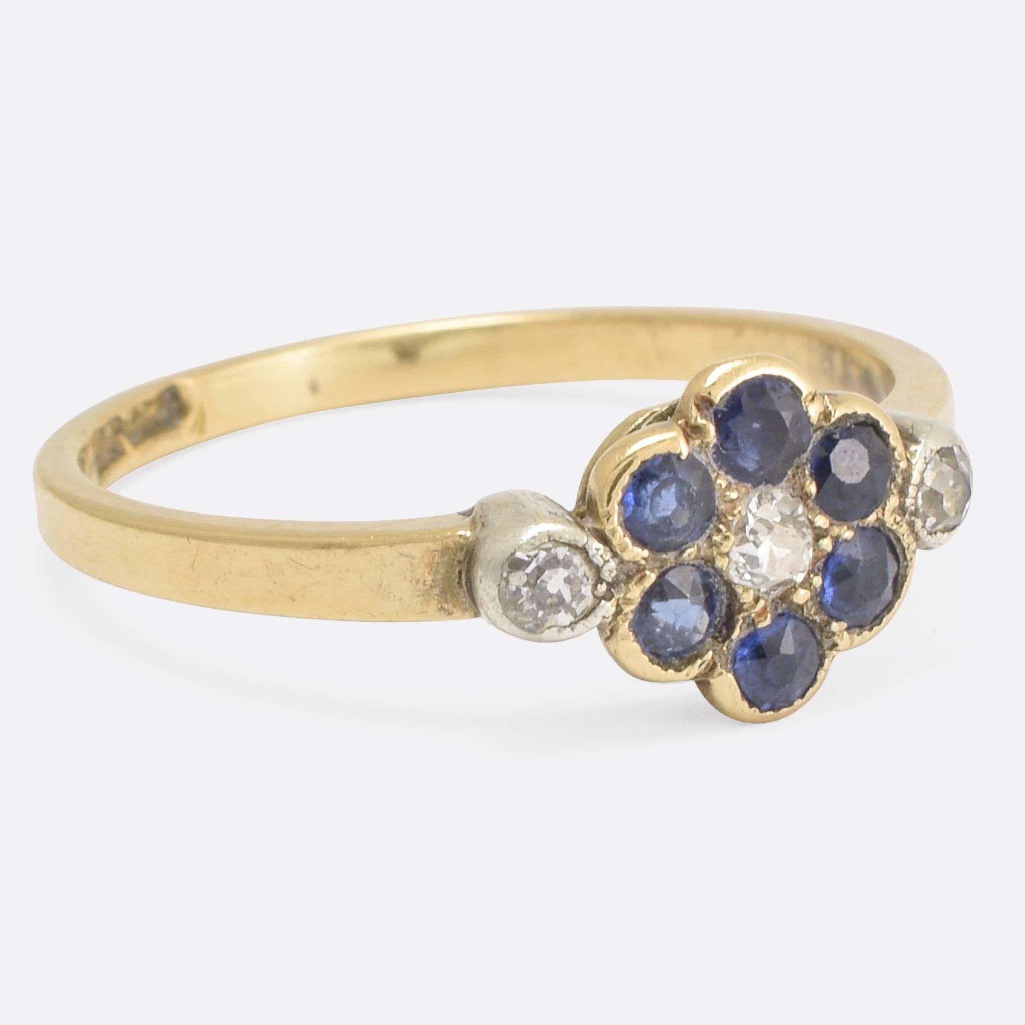 An adorable antique sapphire and diamond cluster ring, modelled in 18k gold and platinum. It dates to the Edwardian era, c.1910 - with the head modelled as a daisy (or similar flower). A wonderful combination of stones: vibrant blue sapphires and