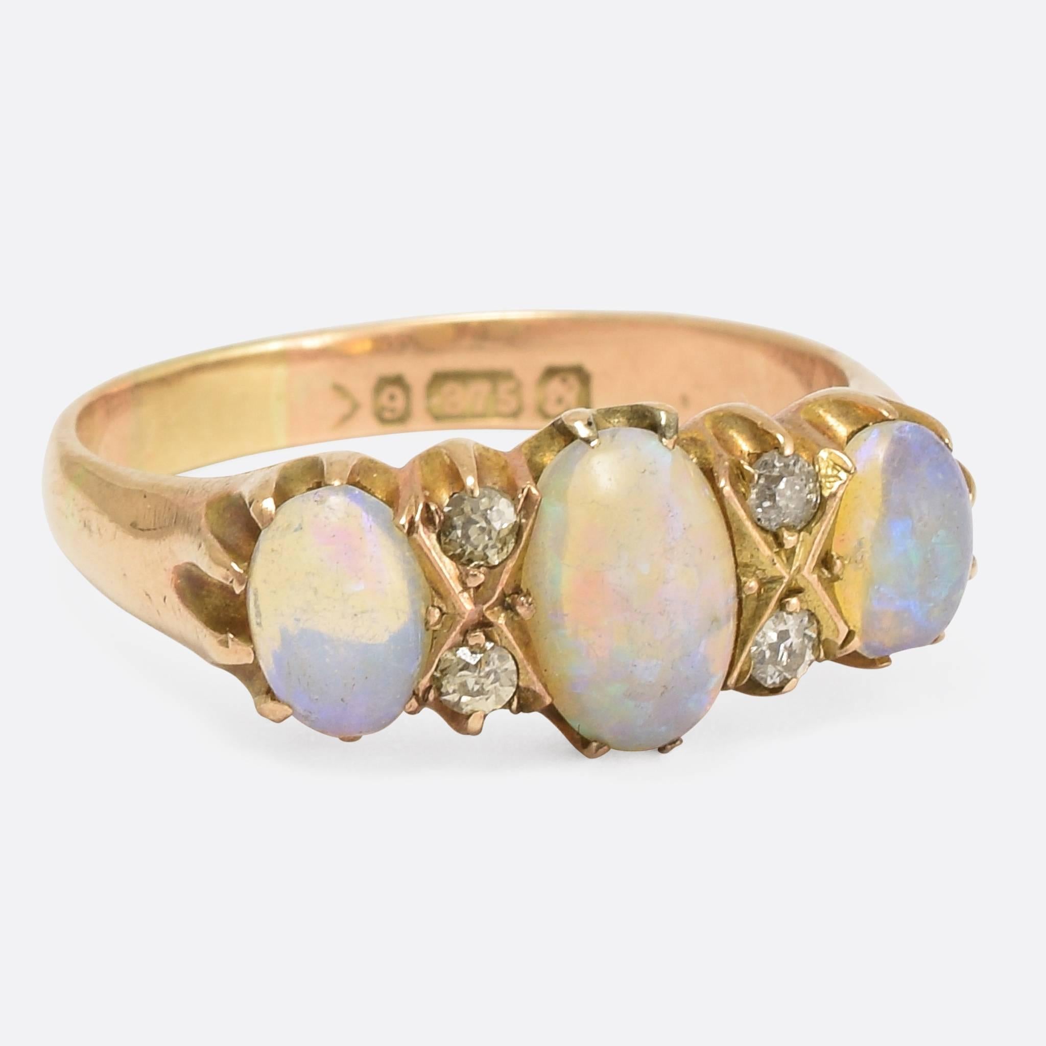 A sweet Edwardian period Opal and Diamond gypsy ring, with claw settings, the richly coloured opals displaying blues, greens & yellows are interspersed by the sparkling white old mine cuts. Modelled in 9k gold, the ring bears clear Chester hallmarks