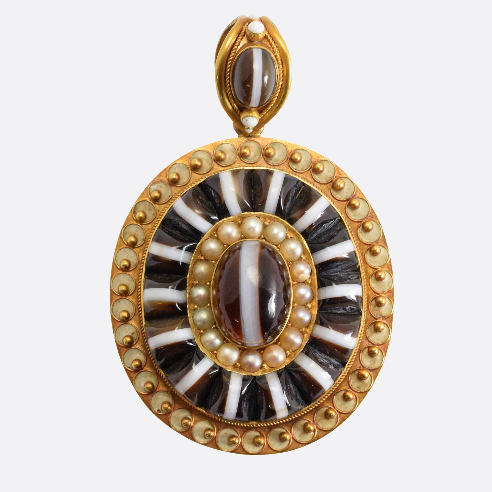 An exceptionally high quality 18k gold etruscan revival locket, the main body set with incredible trapezium cut banded agate cabochons surrounding a central halo of natural pearls. The original bail with rope work detailing, pearls and agate. The