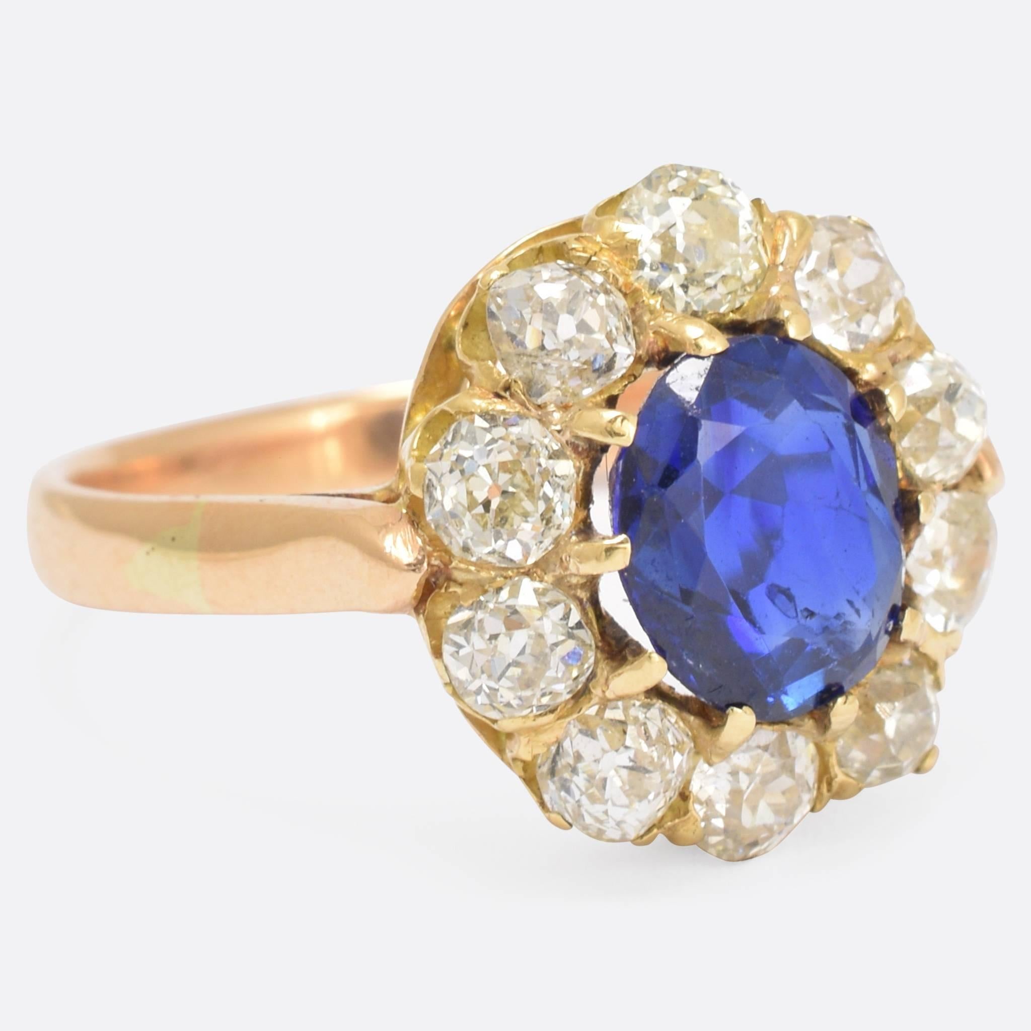 This stunning oval cluster ring is set with a natural (no heat) Sapphire, and 1.8cts of old cut Diamonds. It dates to the late Victorian era, c.1900, and bears a striking resemblance to the engagement ring worn by Princess Diana. With a vibrant