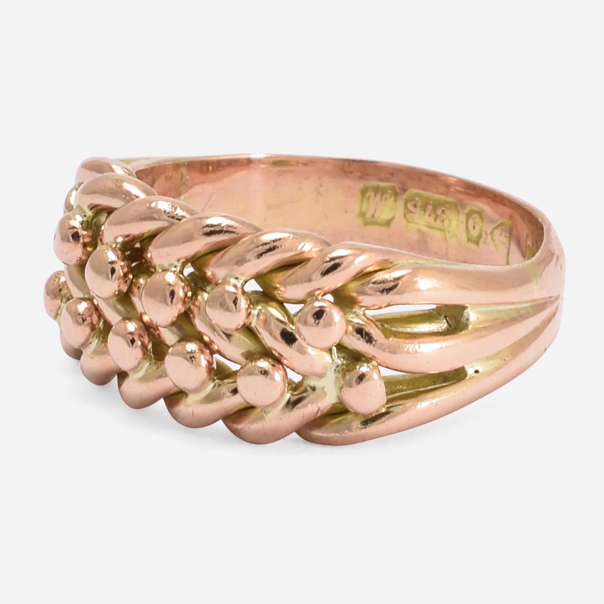 A classic early 20th Century braided keeper ring, modelled in rose gold it dates to the year 1912. A fine example of the style, keeper rings were intended to be worn above wedding bands and engagement rings in order to stop them falling off. In the