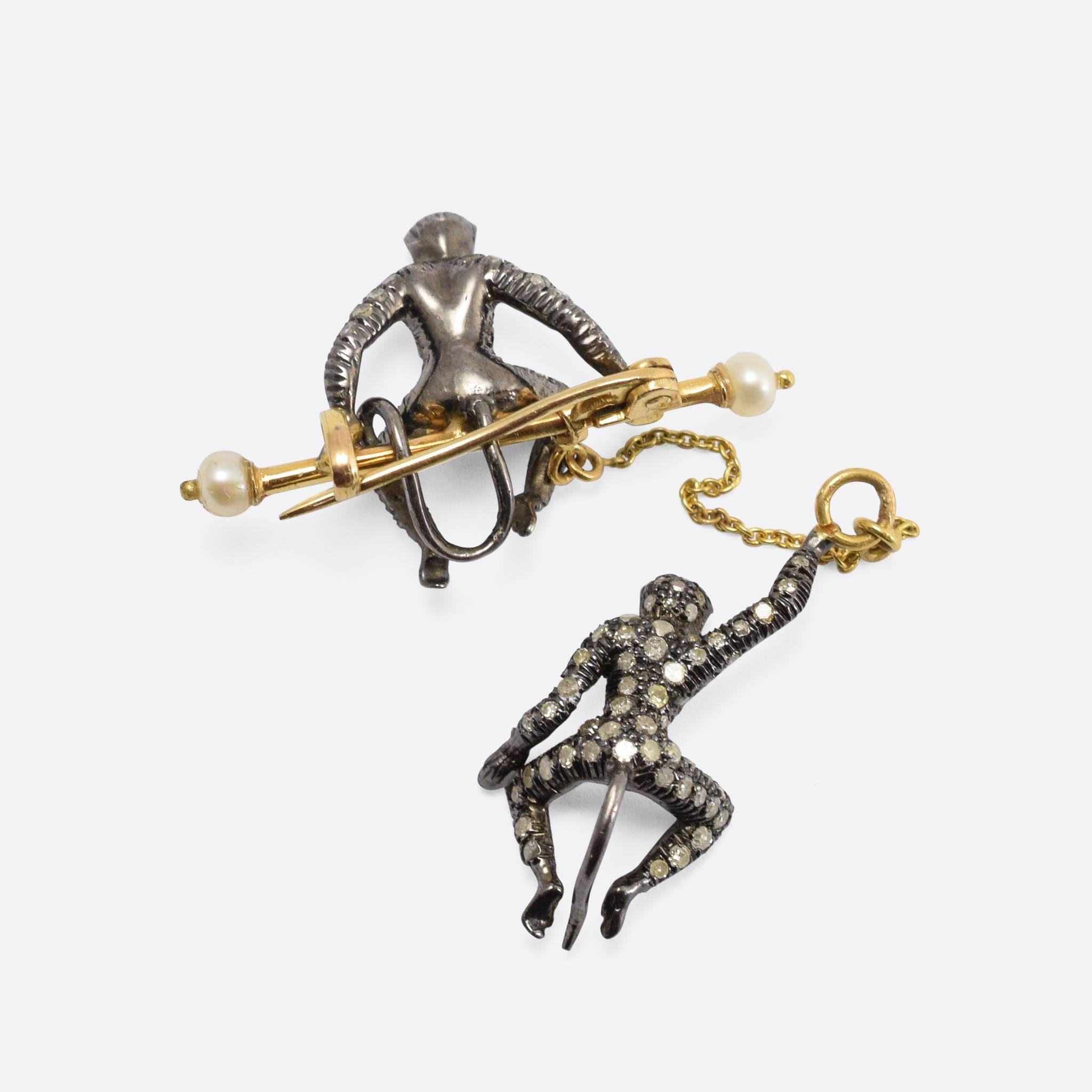 A cool 1960s novelty brooch: two diamond studded monkeys, the top one is sitting on a gold bar (with pearl ends), while the bottom monkey swings from a chain. They have rubies for eyes, and the diamonds continue around their backs too - unusual for