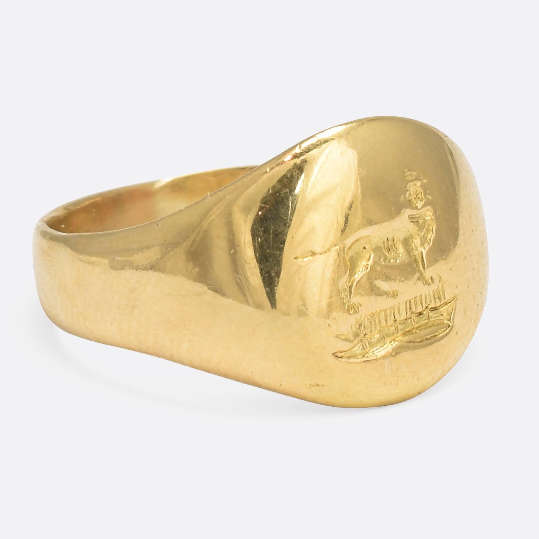 A cool antique pinky ring, modelled in 18k gold and carved with an intaglio crest depicting a lion stood atop a coronet (small crown). It's fully hallmarked from the London assay office, in the year 1914. An elegant piece of Edwardian history, this