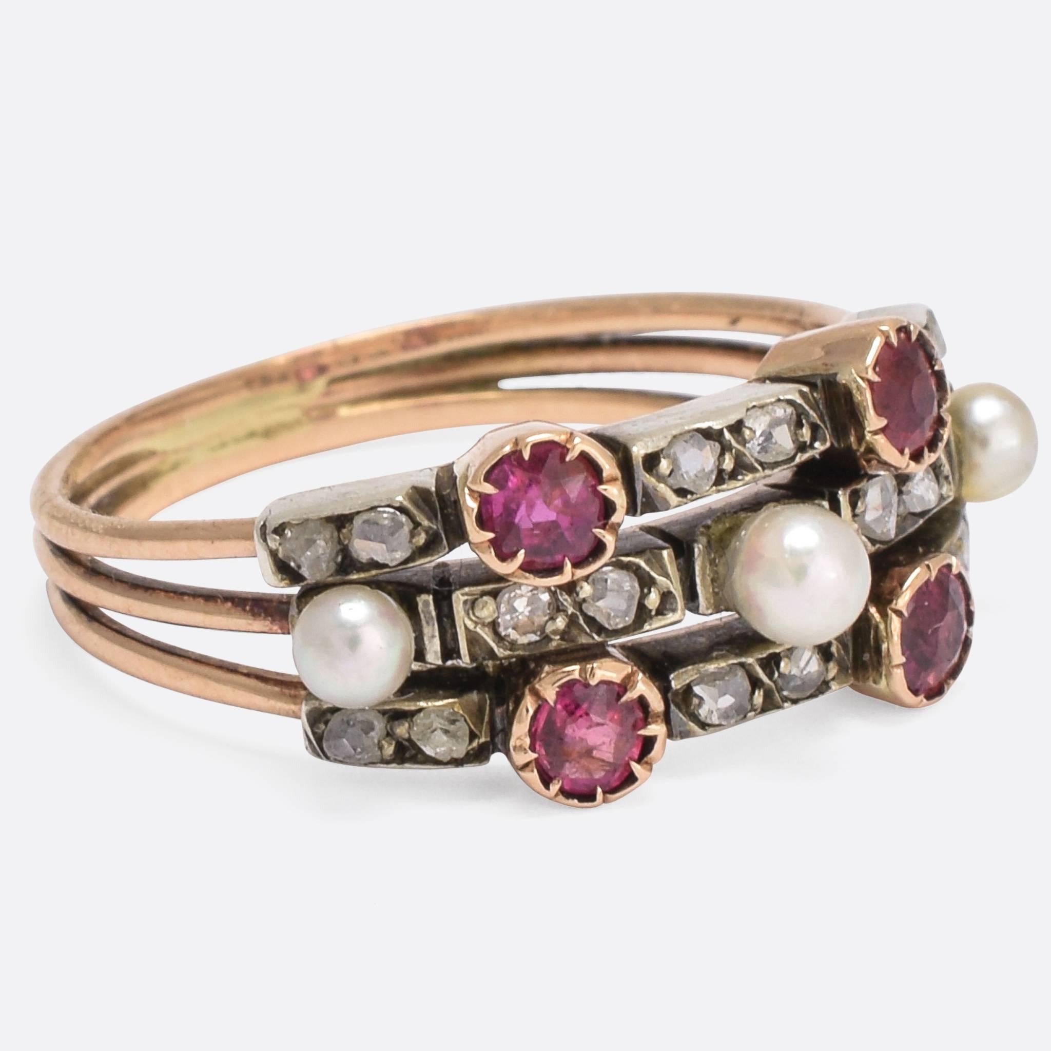 A beautiful three-band harem ring set with pearls, rubies, and rose cut diamonds. It dates to the late Victorian era, c.1900 - modelled in 15k gold with the diamonds set in detailed silver mounts. A fine example of the style.

STONES
Ruby, Diamond,