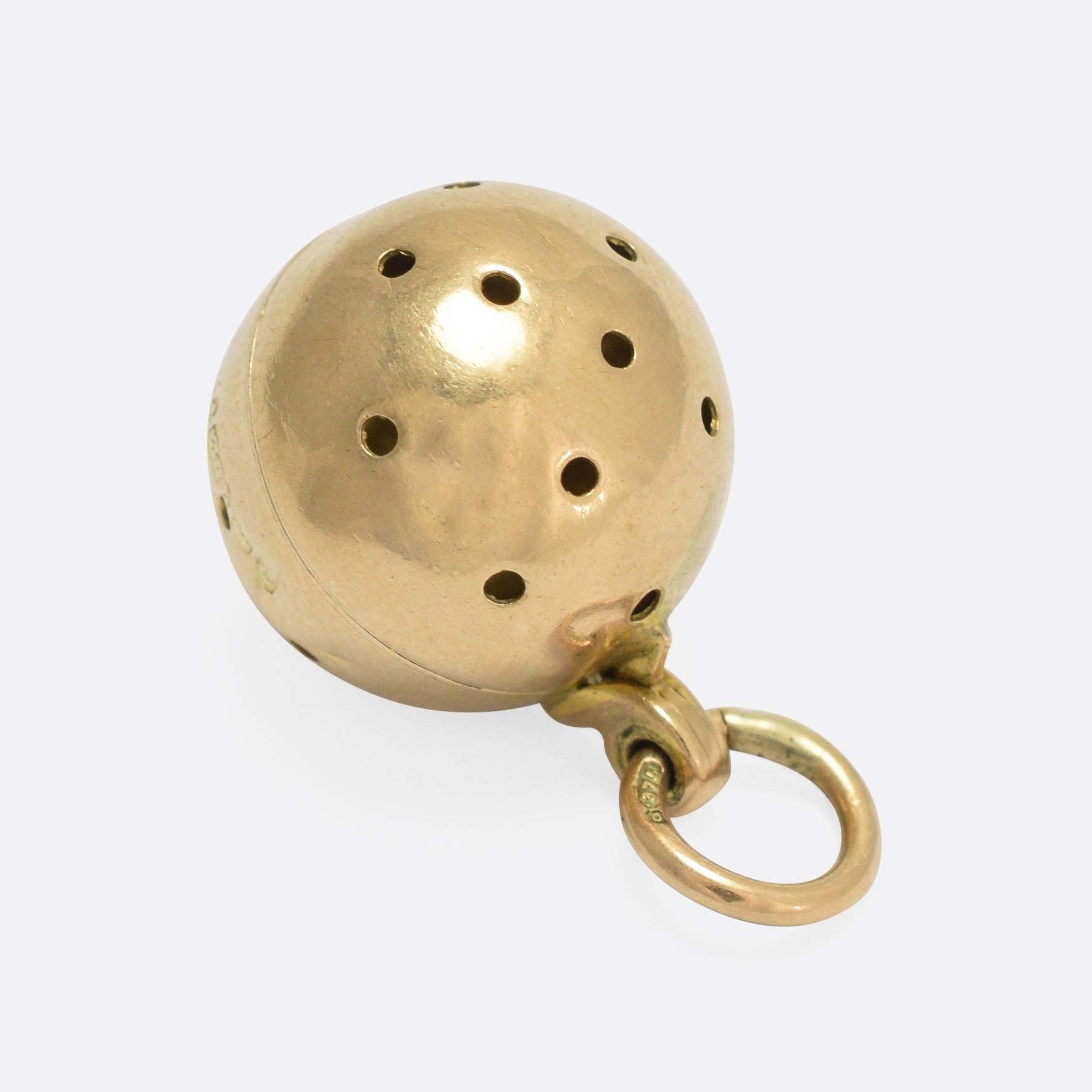 An unusual - and very sweet - vinaigrette pendant, modelled as an orb with little holes all around. It's crafted from 9k yellow gold, with clear English hallmarks dating to the year 1902 - the very beginning of the Edwardian era. 
This style of
