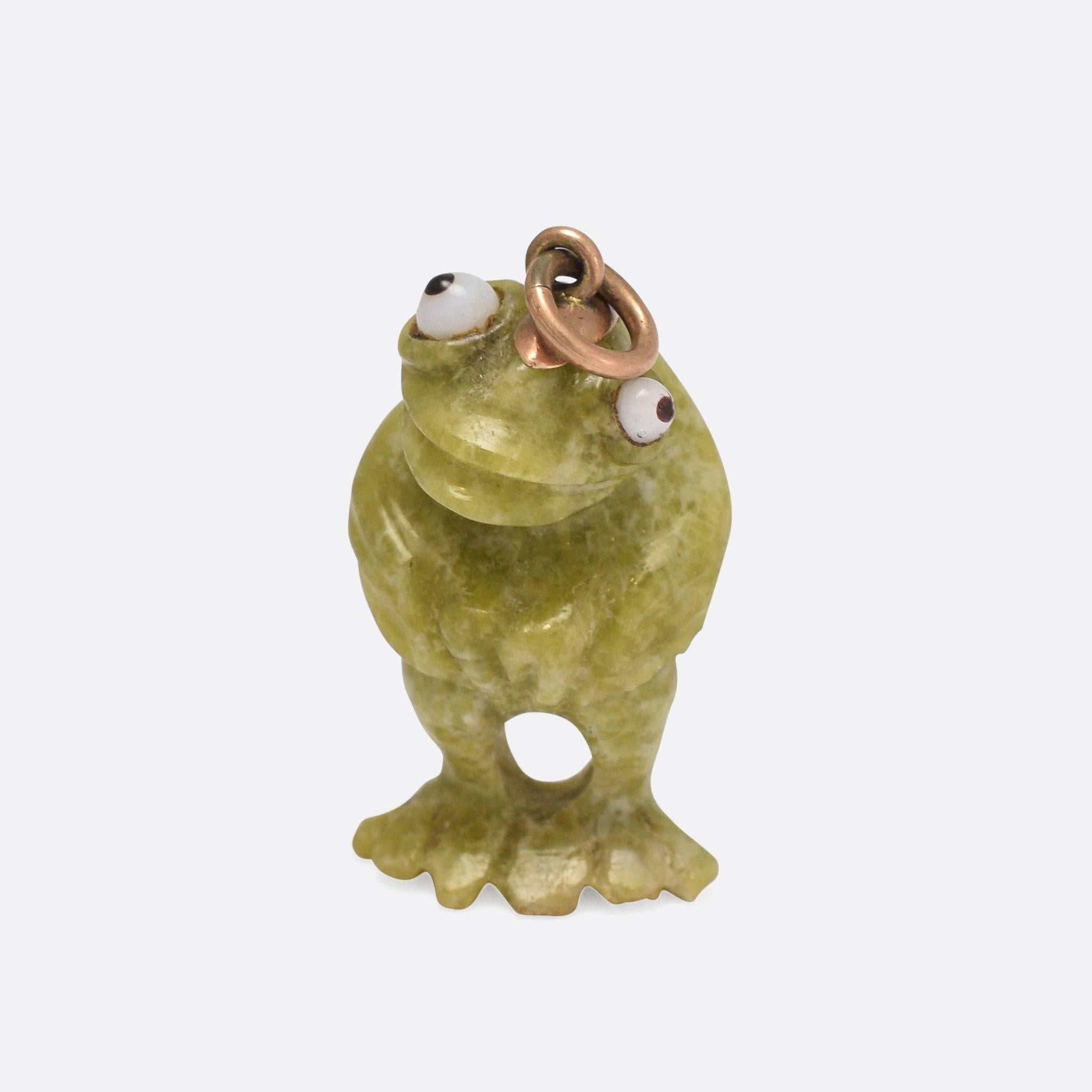 An unusual antique frog pendant, carved from a single piece of Irish Connemara Marble. The frog has different sized glass eyes, giving a comedic feel to the piece. With gold fittings for wear as a pendant, the carving is executed very well indeed.