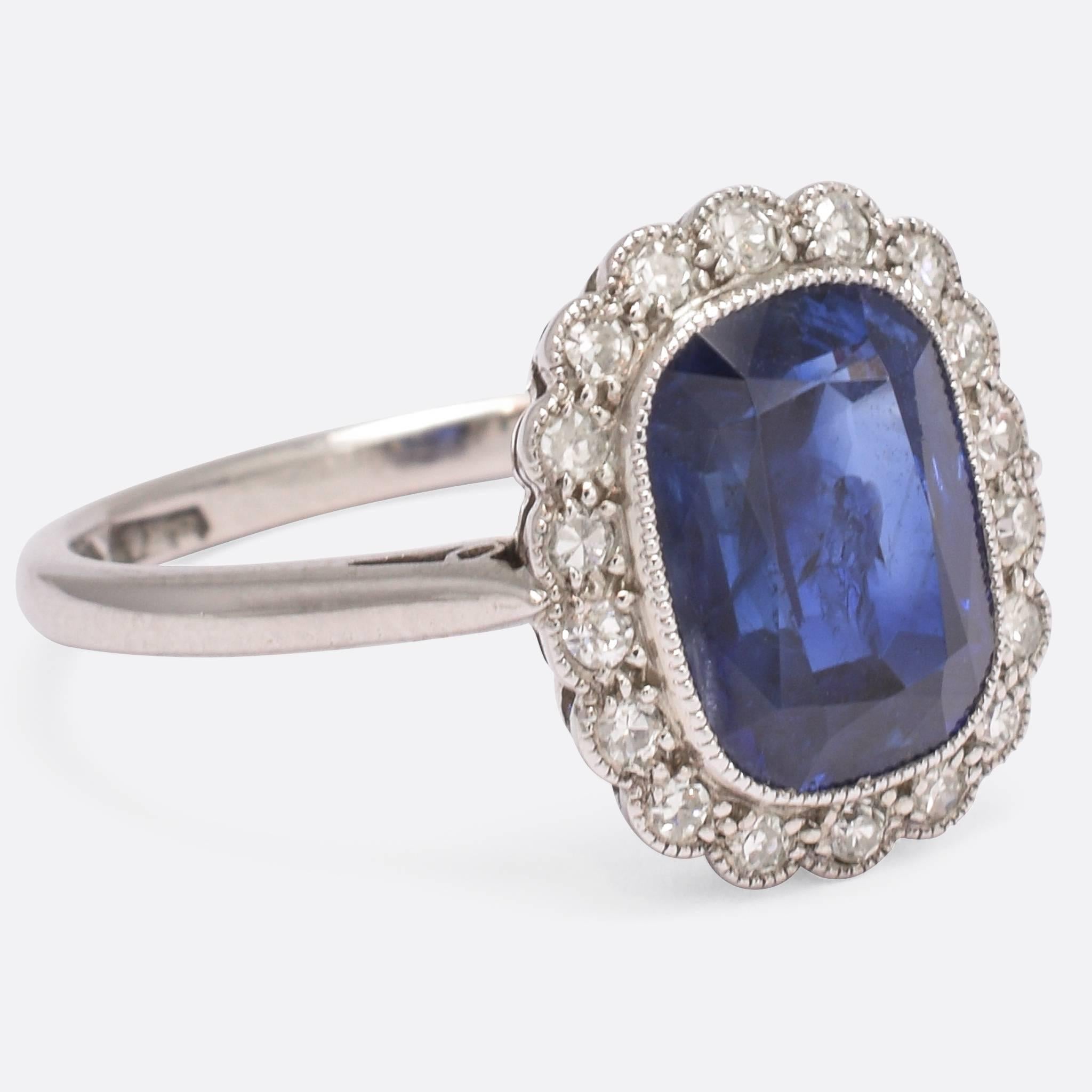 A sublime Edwardian period natural Sapphire and diamond cluster ring, modelled in platinum throughout. The principal 3 carat stone displays excellent colour - a vivid Royal Blue, likely of Burmese origin - while the eight-cut diamonds are bright