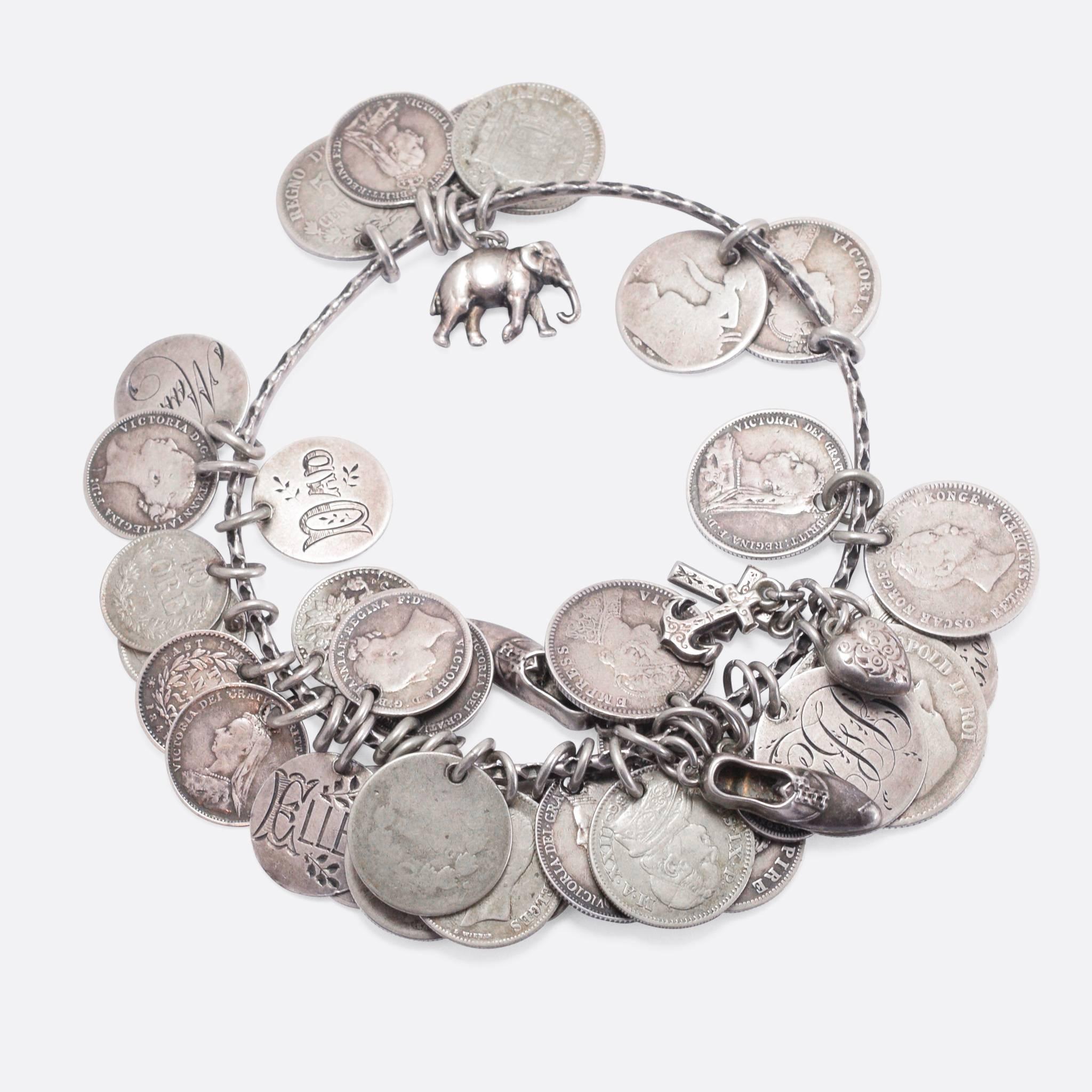 An original late Victorian Love Token bangle, set with a selection of charms and coins. Many of the coins have been filed down on one side, and then engraved with a name (or sometimes an image such as the piano pictured) - they are mainly 