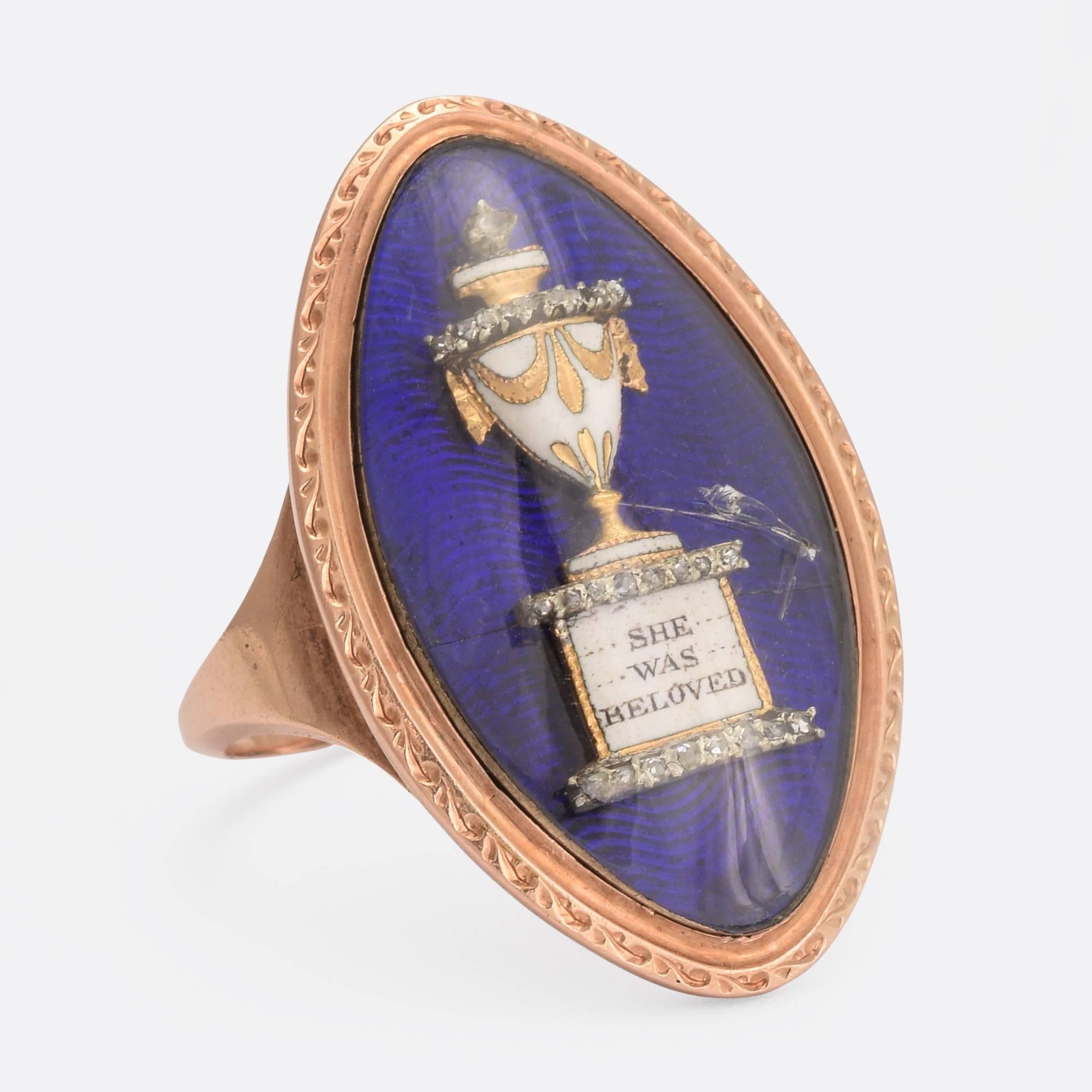 A stunning Georgian navette memorial ring. The head, behind glass, features a white enamelled urn sitting atop a plinth with the words 