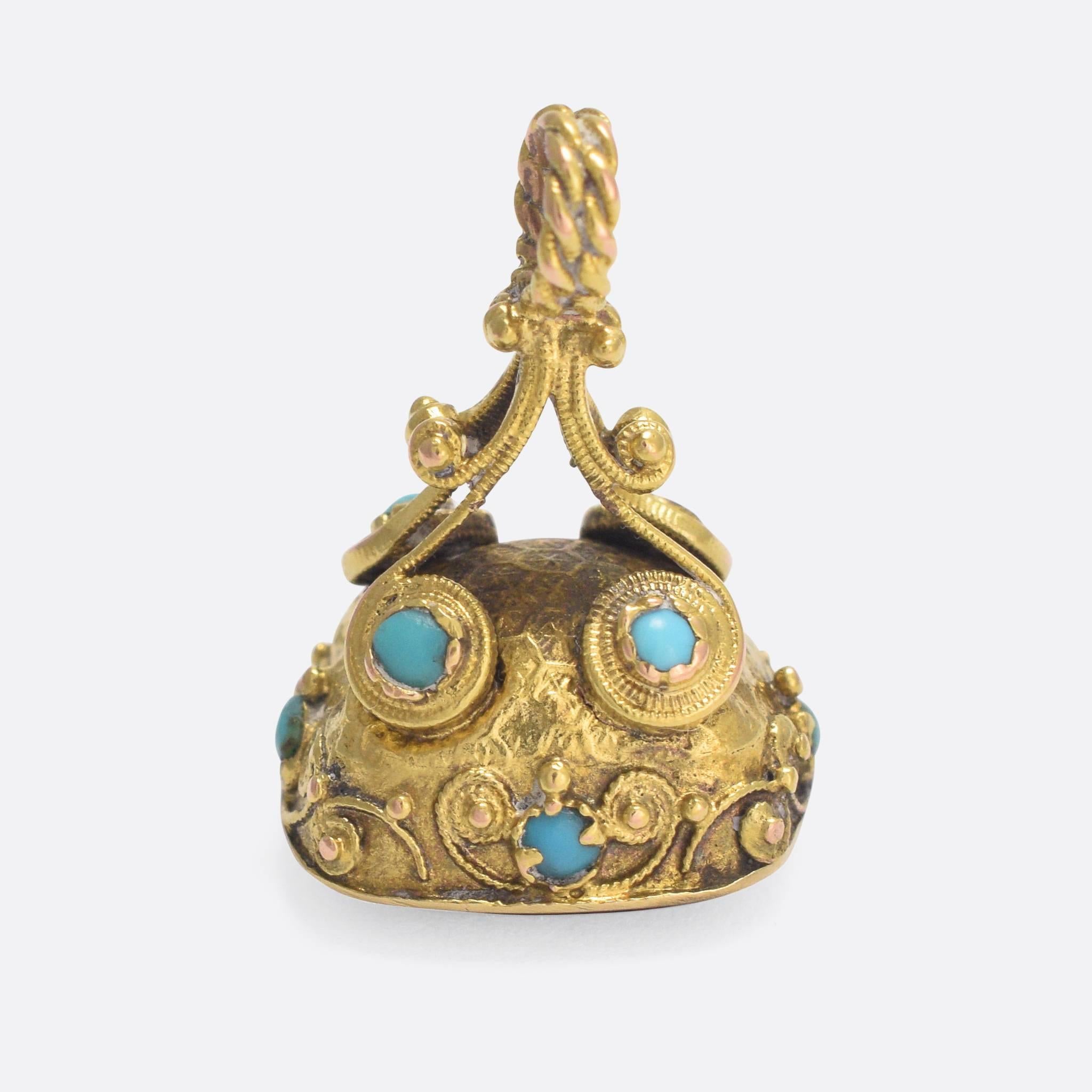 A beautiful antique seal fob dating to the early 19th Century. Featuring exceptionally intricate Cantille goldwork, the piece is set with small turquoise cabochons and an uncarved bloodstone panel. The frame comprises fine beaded ropework, while the
