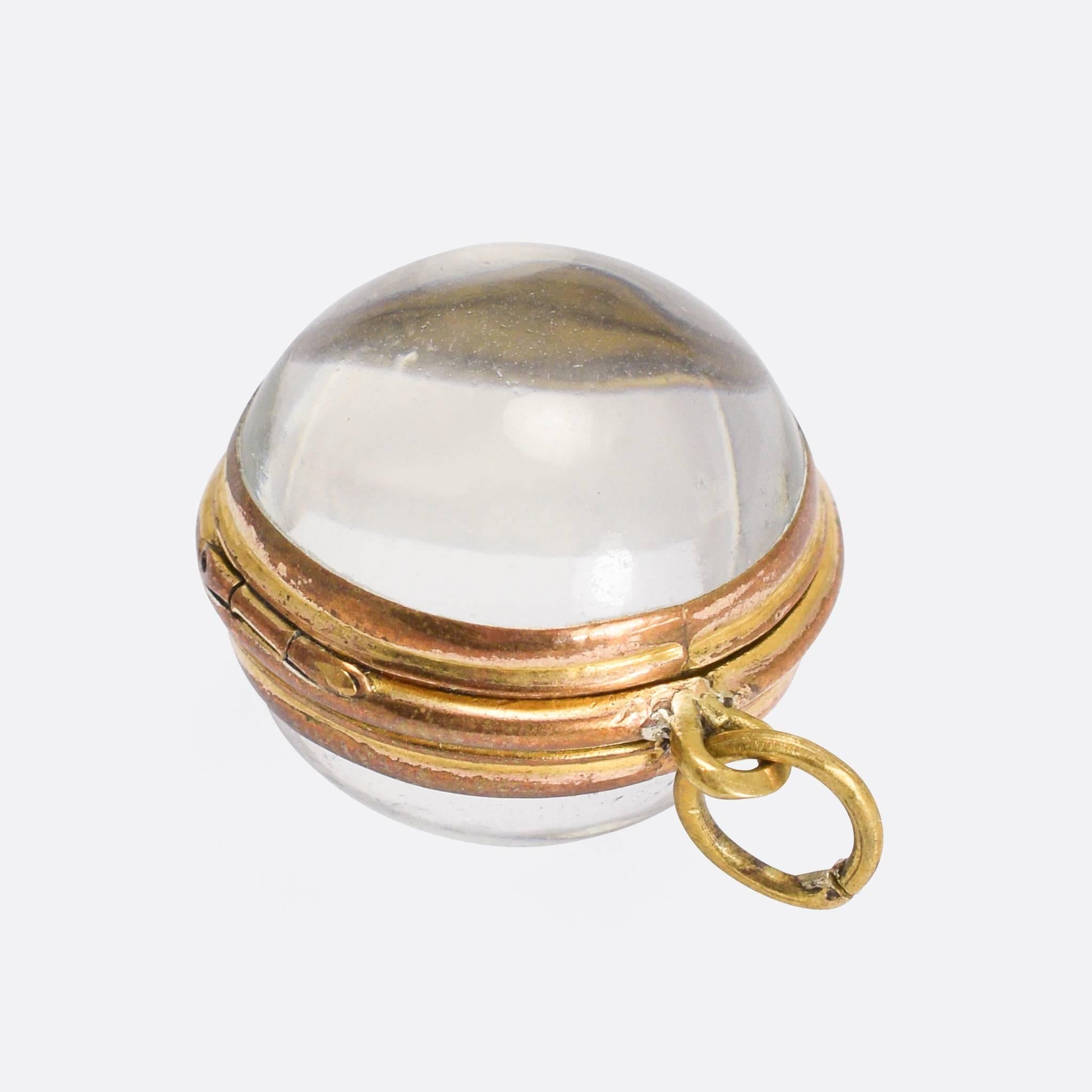 A beautiful Victorian pool-of-light locket. Comprising two rock crystal hemispheres, the piece is hinged down one side and opens up to store a photograph or other keepsake. The real beauty of the piece is the way that it captures and focuses the