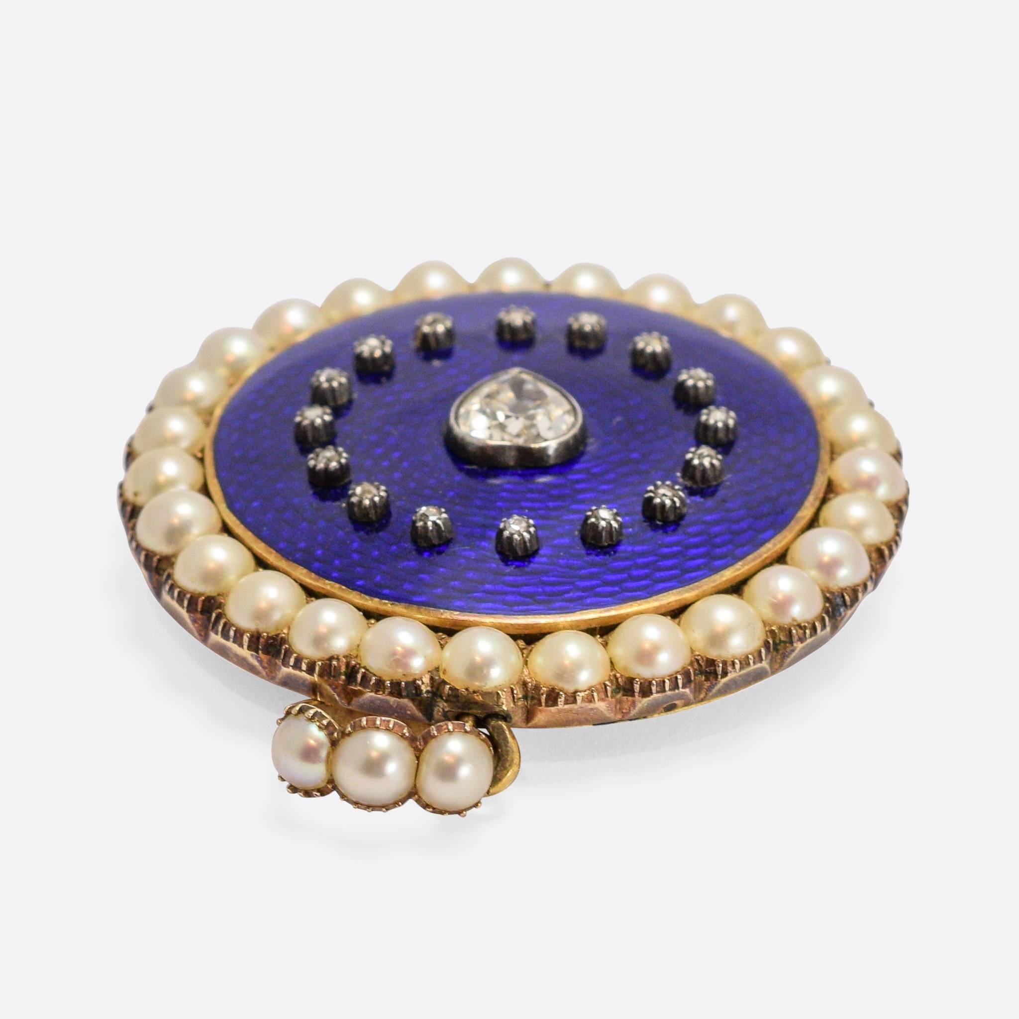 An exceptional early 19th Century locket, with a central pear-shaped diamond (set to look like a heart) within a halo of rose cuts and an outer halo of natural pearls. The front is finished in fine guilloché enamel - a vitreous Royal Blue in colour