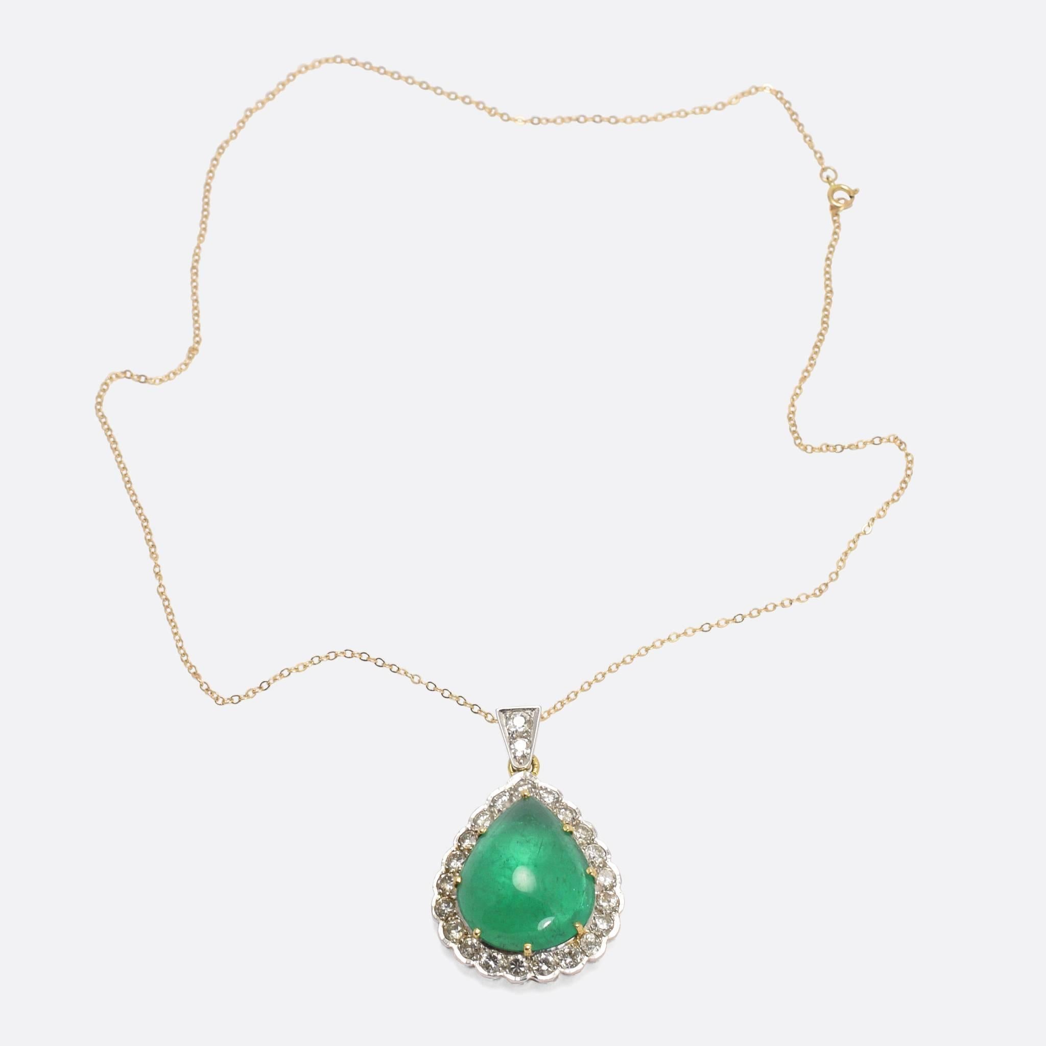 A superb vintage teardrop pendant, set with a stunning 22.5 carat emerald cabochon. The marvellous stone has a diamond halo surround (totalling 1.5ctw) and an original diamond set bail. With french marks for 18 karat gold, this exceptional piece